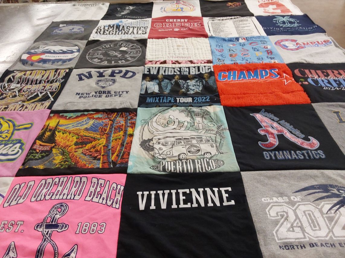 T-shirt quilt with gymnastics, cheerleading themes by Heather from CO