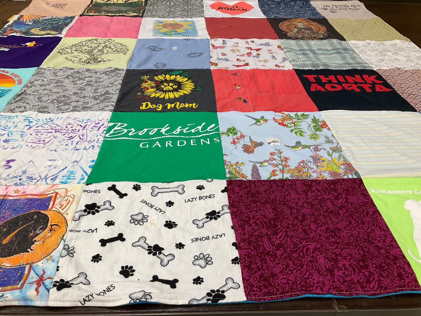 T-shirt quilt with dogs, gardening themes by Mary Ann from MD
