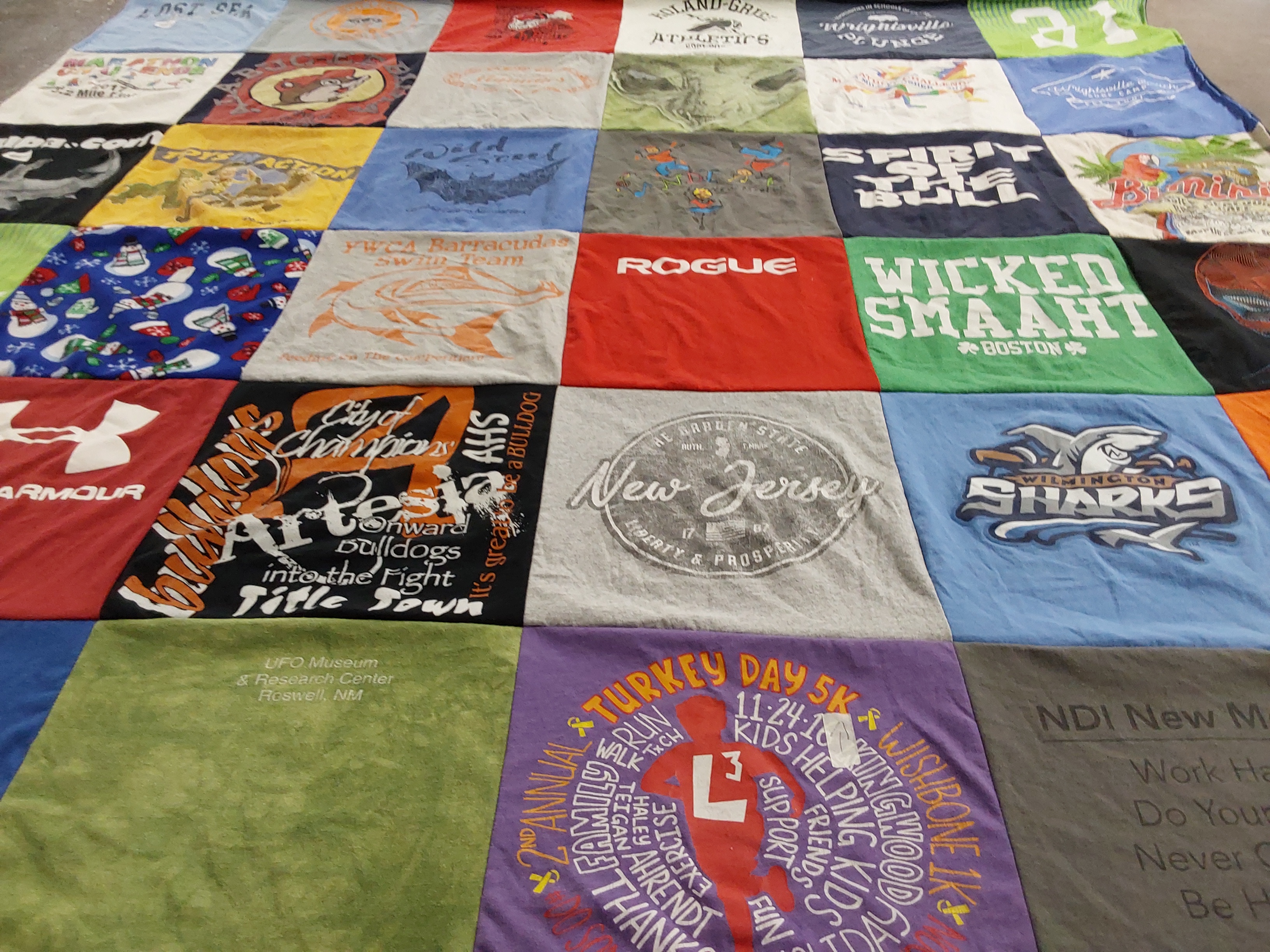 T-shirt quilt featuring wilmington sharks, ywc barracudas swim team by Francis “Annie” from NC