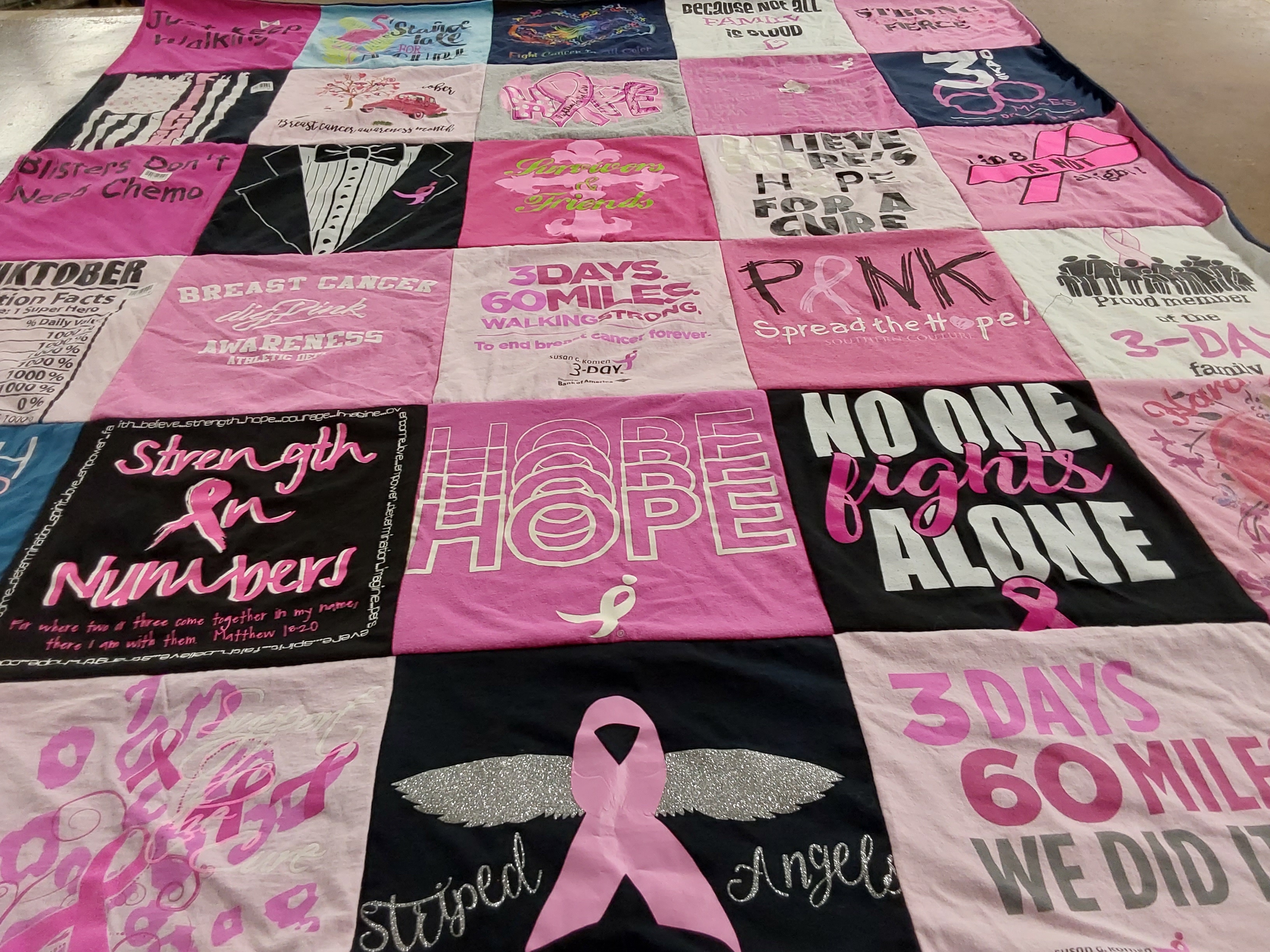 T-shirt quilt with breast cancer awareness, charity events themes by Joylynn from TX