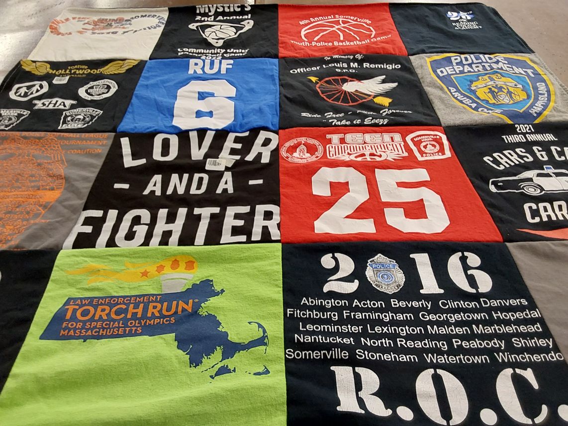 T-shirt quilt with sports, law enforcement themes by JENN from MA
