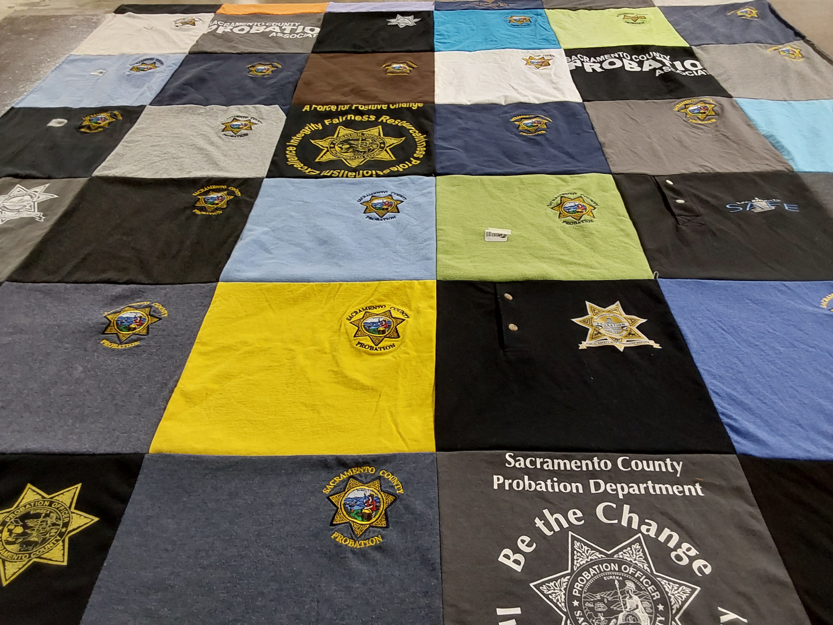 T-shirt quilt with law enforcement, community service themes by Tanisha from CA
