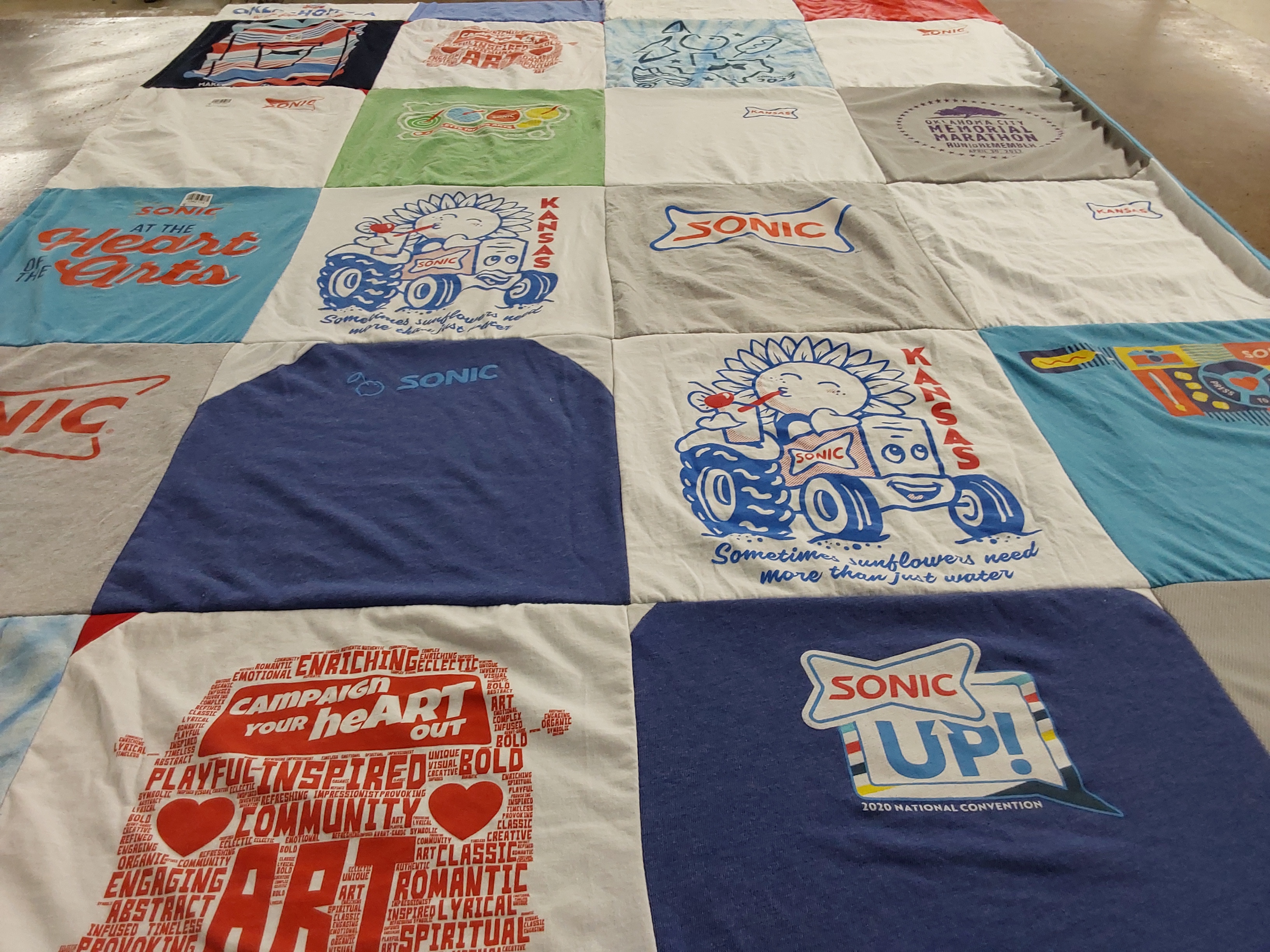 T-shirt quilt with art, community themes by Lisa from OK