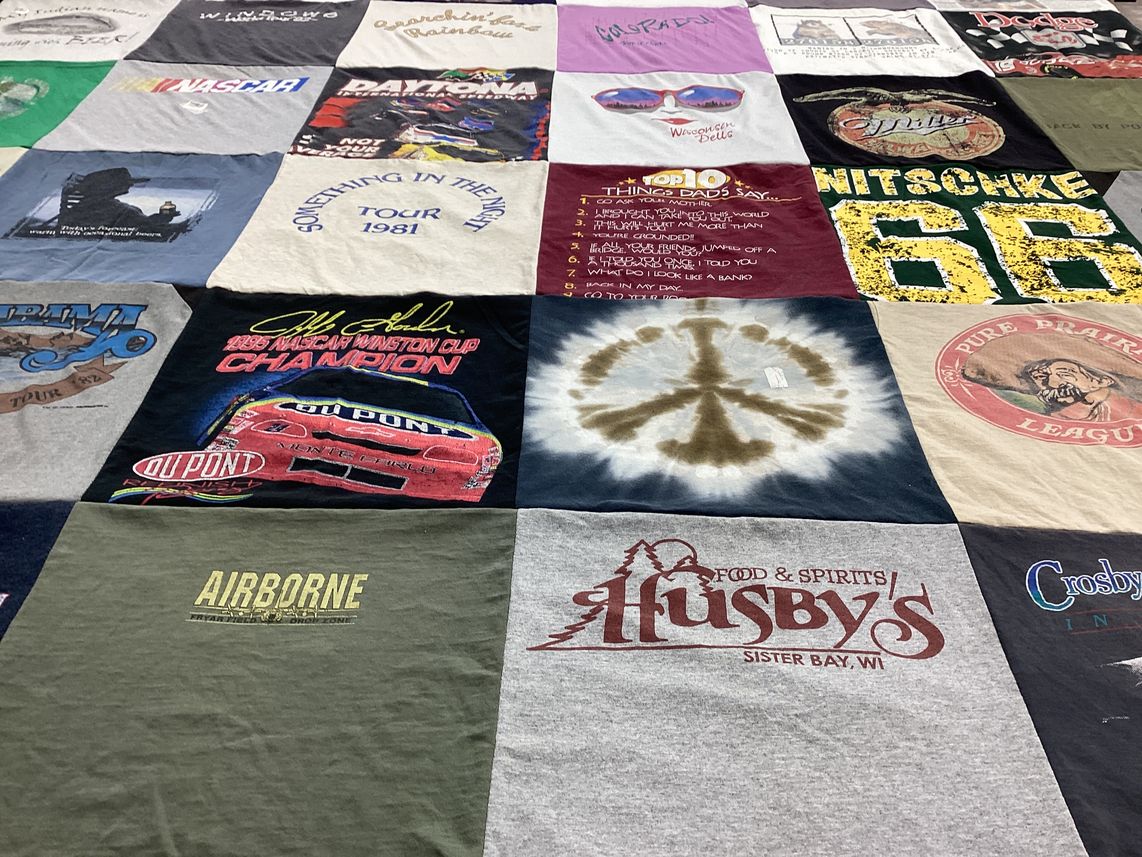 T-shirt quilt with nascar, music themes by Susan from WI