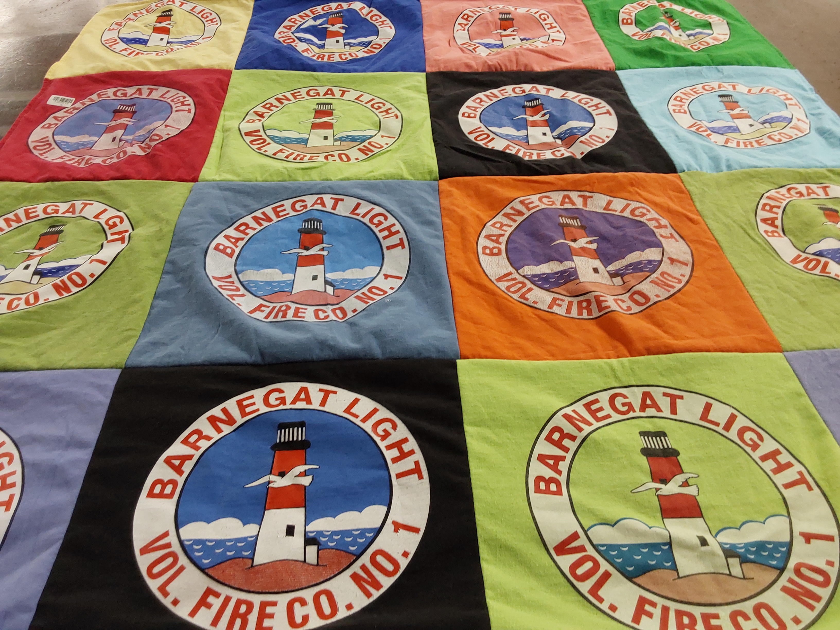T-shirt quilt with lighthouses, firefighting themes by Robert from NJ