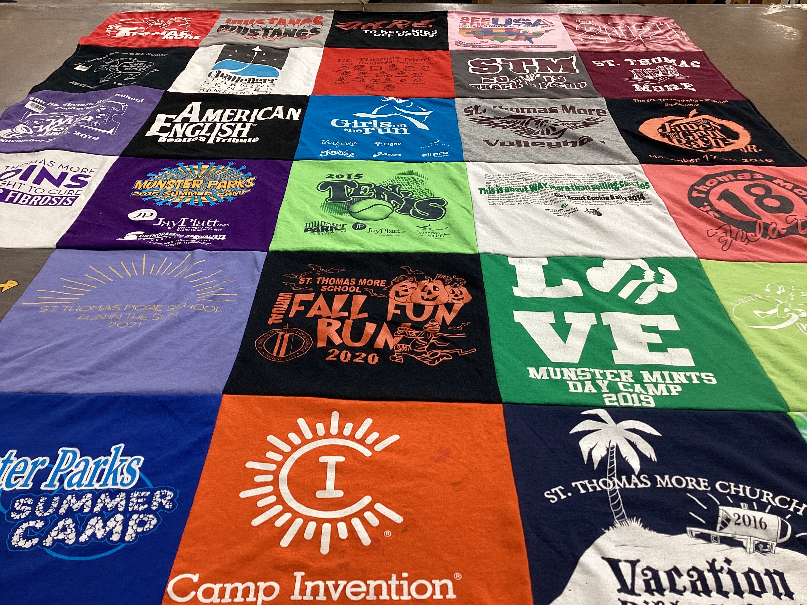 T-shirt quilt featuring st thomas more volleyball, st thomas more track and field by April from IN