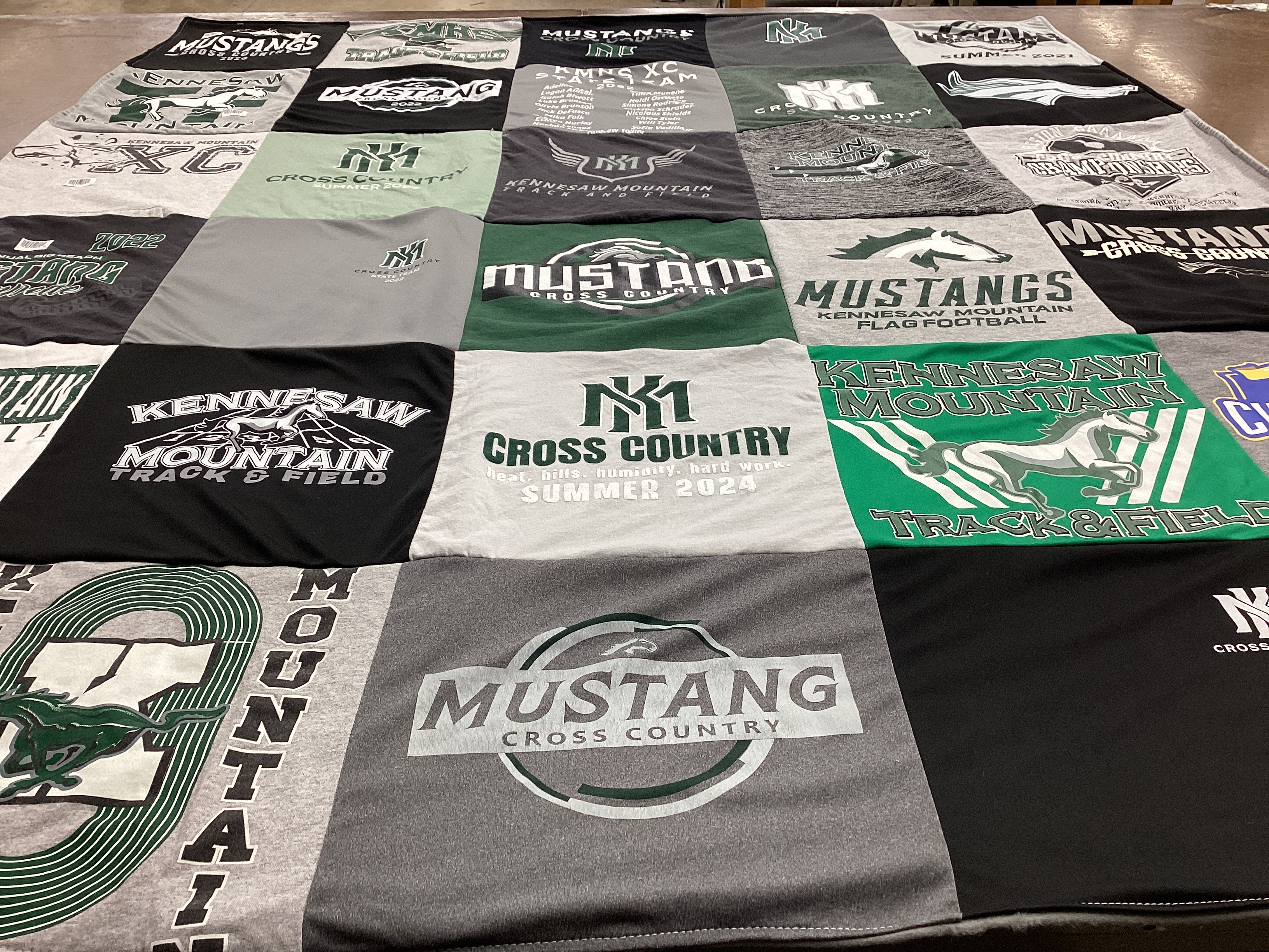 T-shirt quilt featuring kennesaw mountain high school cross country, kennesaw mountain high school track and field by Meredith from GA