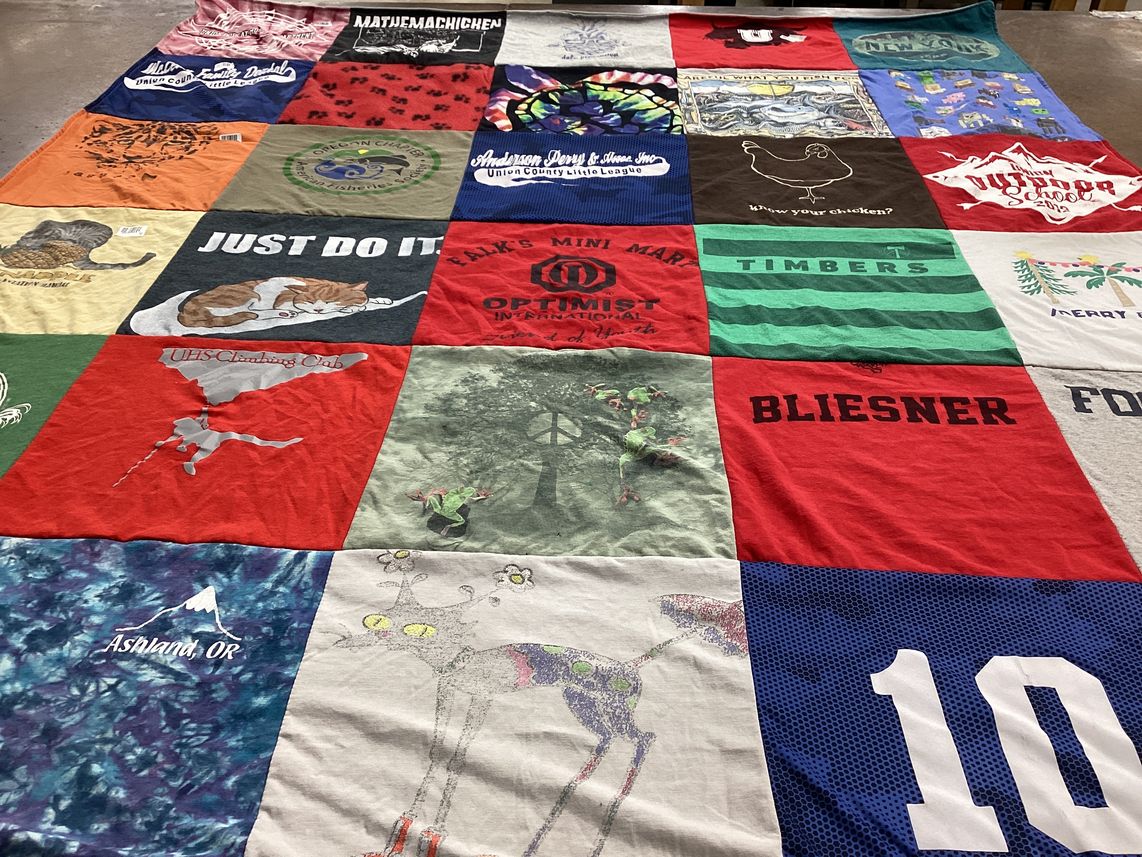 T-shirt quilt with climbing, optimism themes by Kasey from OR