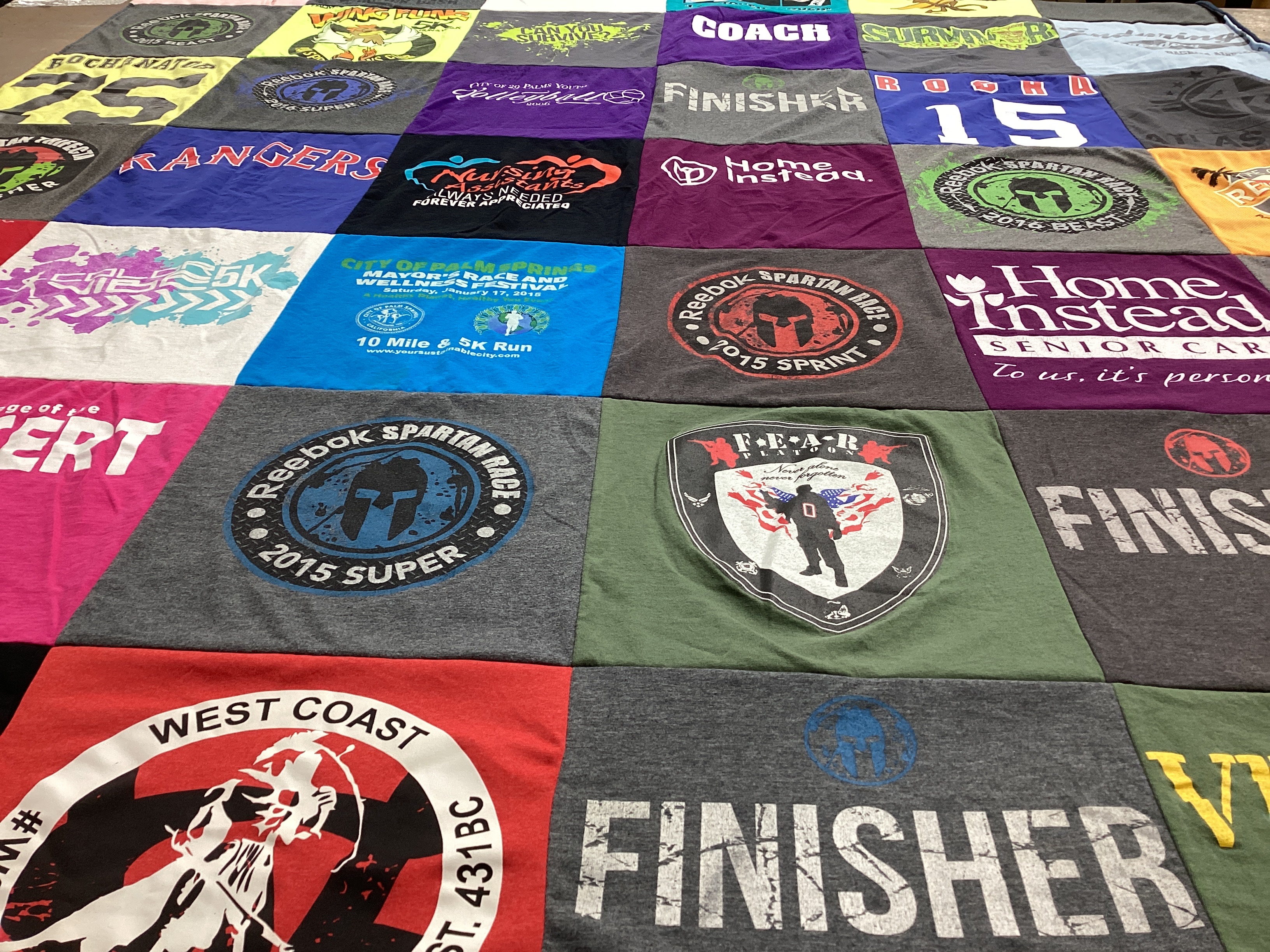 T-shirt quilt with running, obstacle course racing themes by Esther from CA