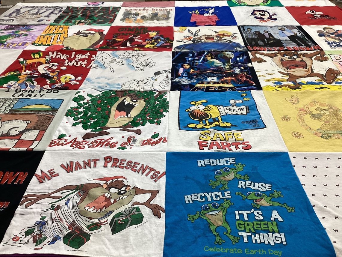 T-shirt quilt with cartoons, environmentalism themes by Marion from CO