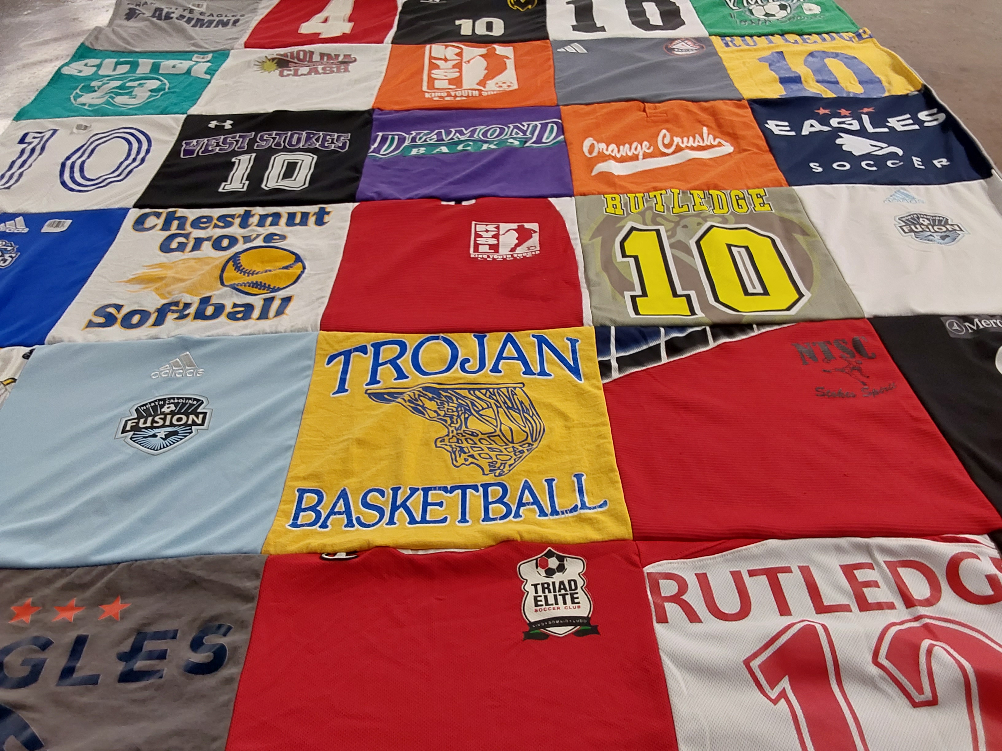 T-shirt quilt featuring trojan basketball team, eagles soccer team by Joy from NC