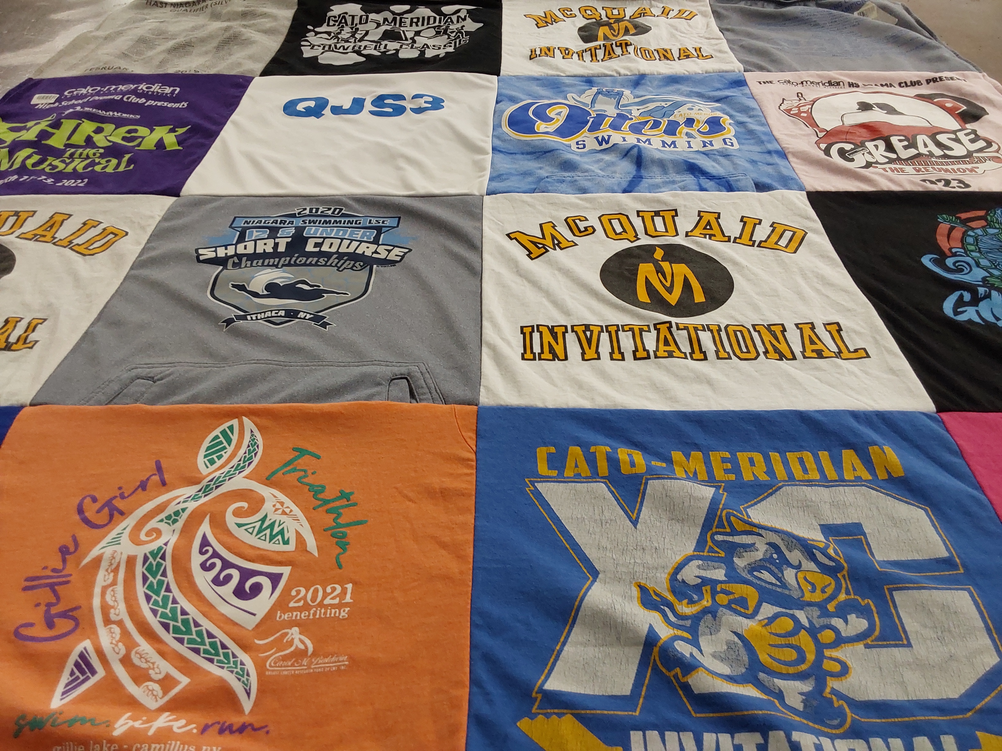 T-shirt quilt featuring mcquaid jesuit high school swimming, catd-meridian cross country by Renee from NY