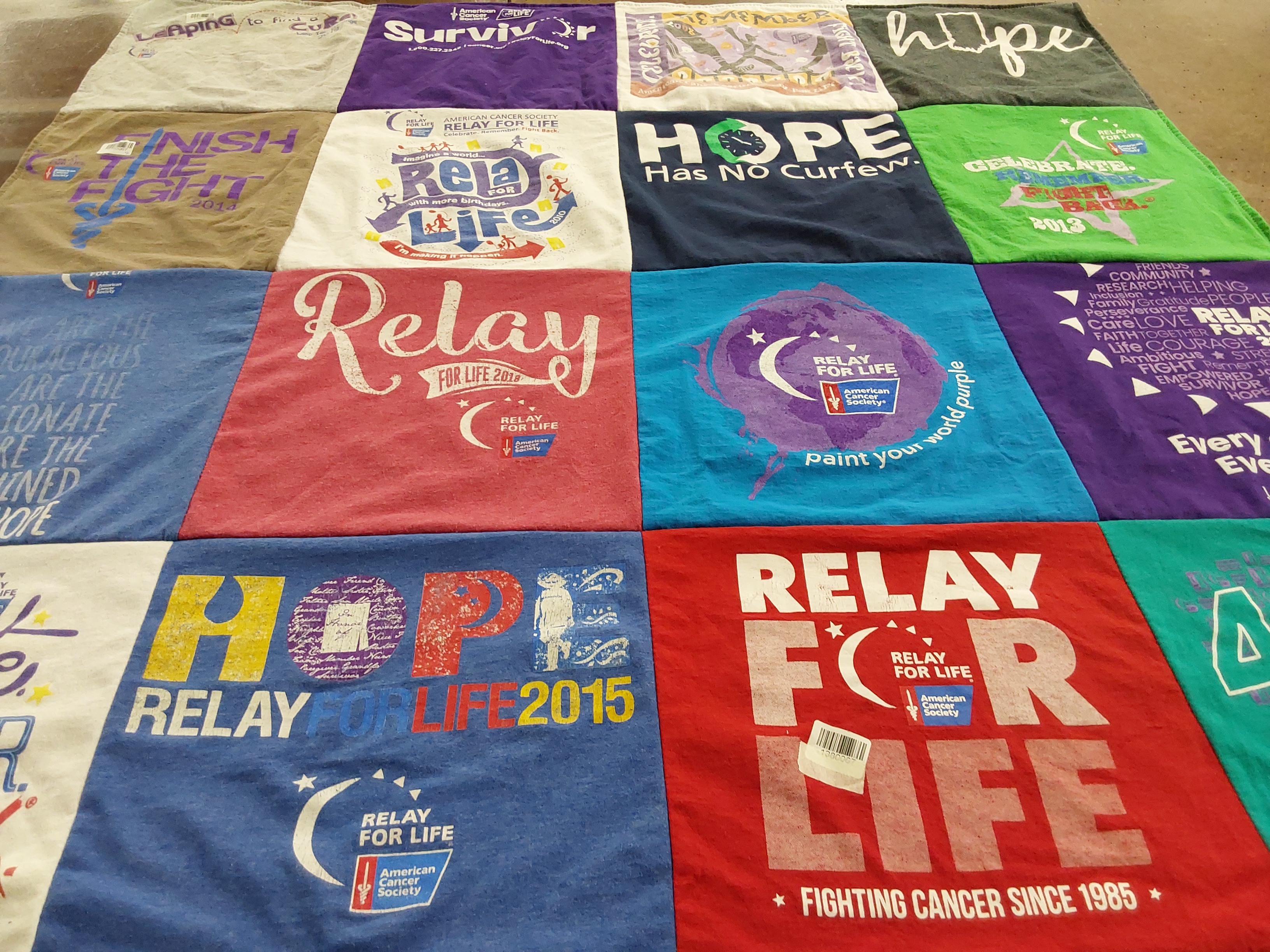 T-shirt quilt with cancer awareness, charity themes by Julie from IN