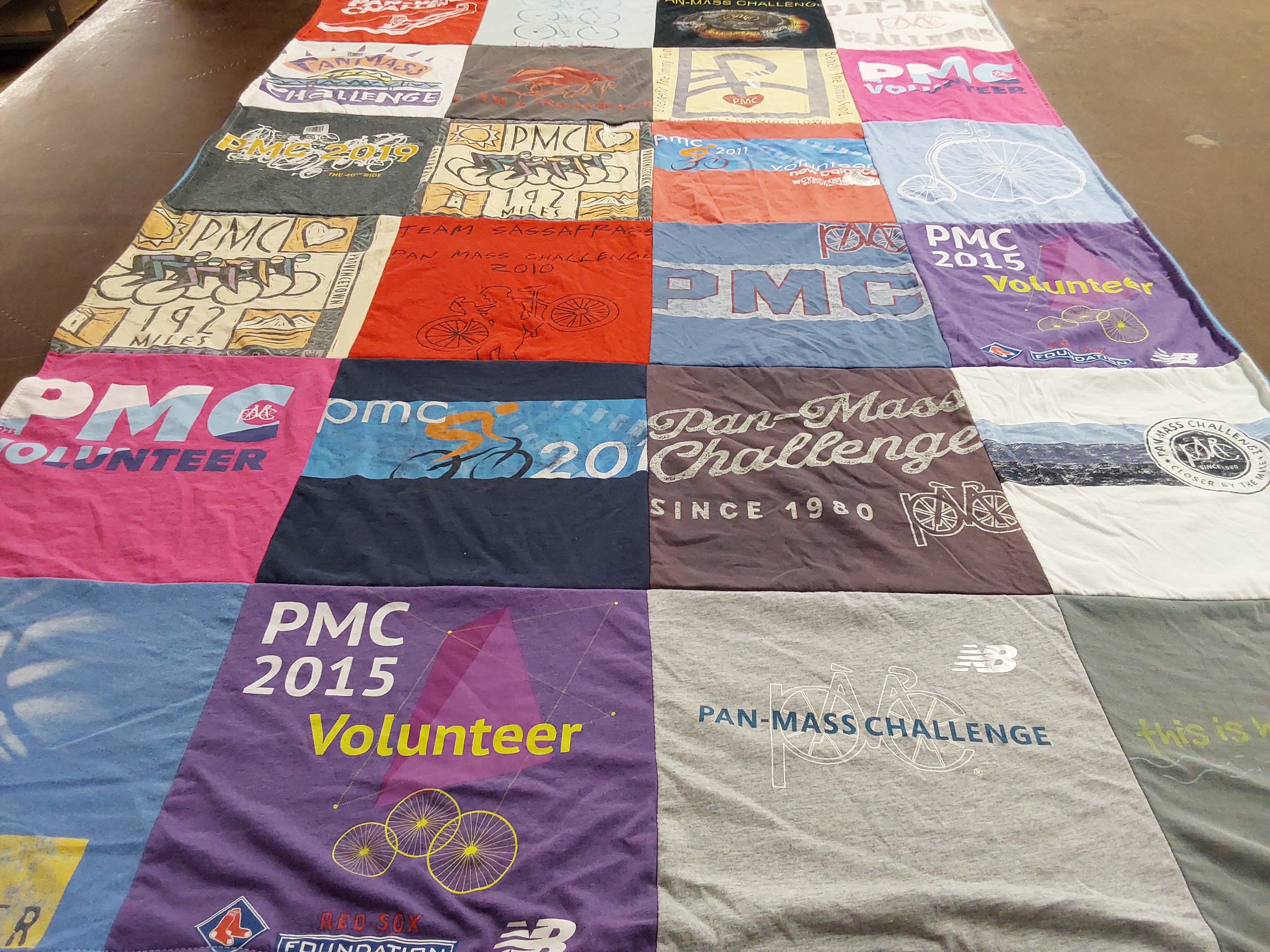 T-shirt quilt with cycling, volunteering themes by Marilyn from CT