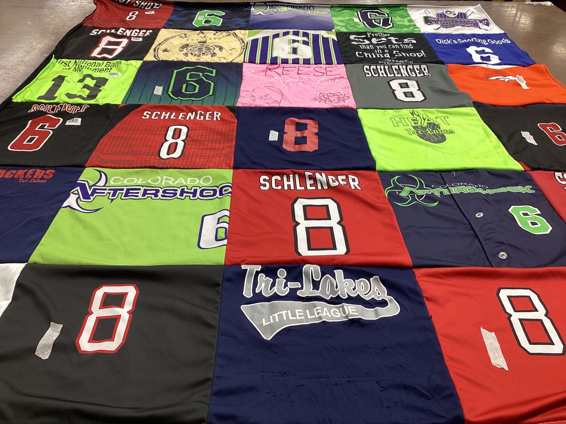 T-shirt quilt with sports, community activities themes by stephanie from CO