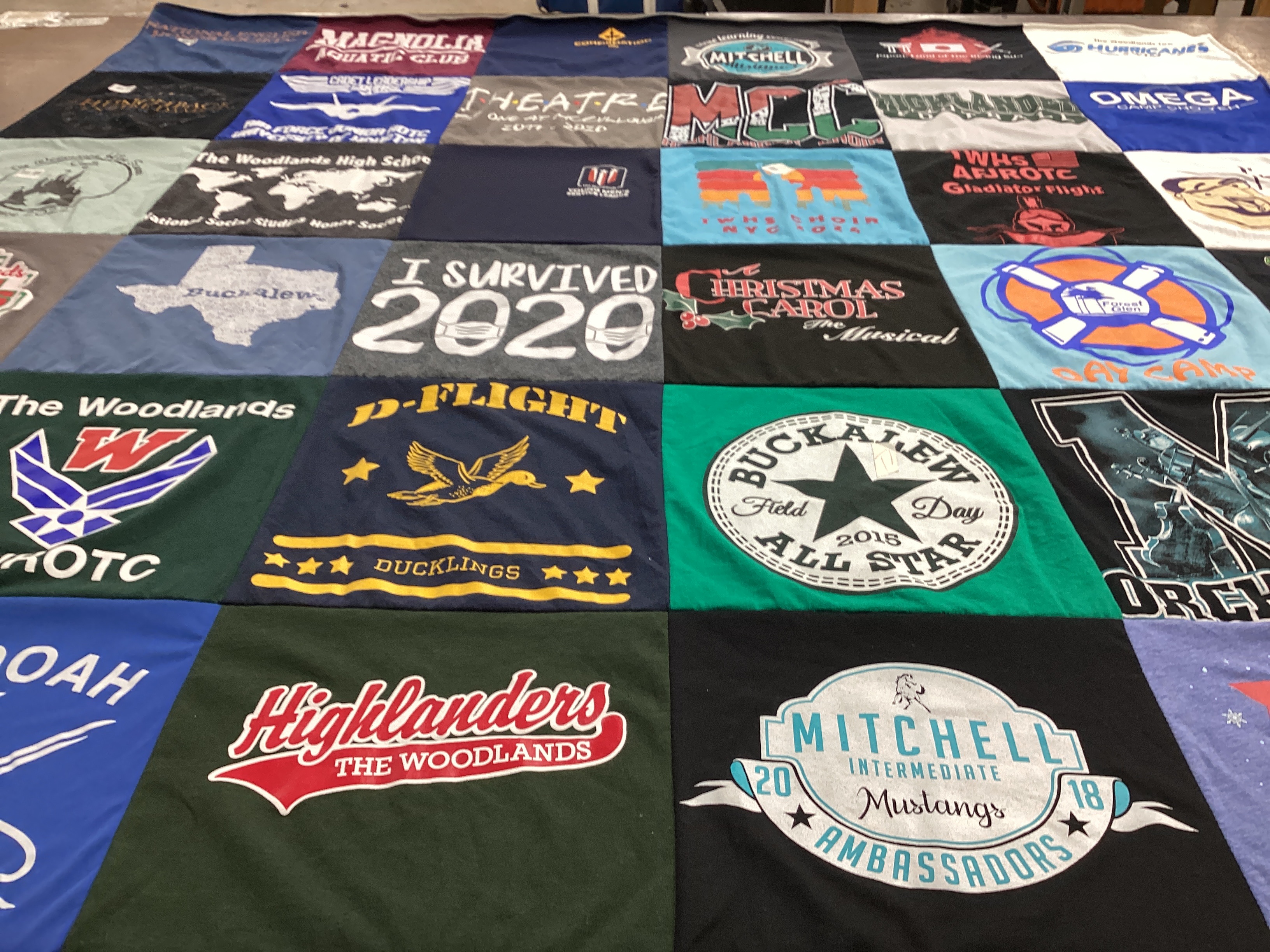 T-shirt quilt featuring mitchell intermediate mustangs, the woodlands high school ducklings by Cathi from TX