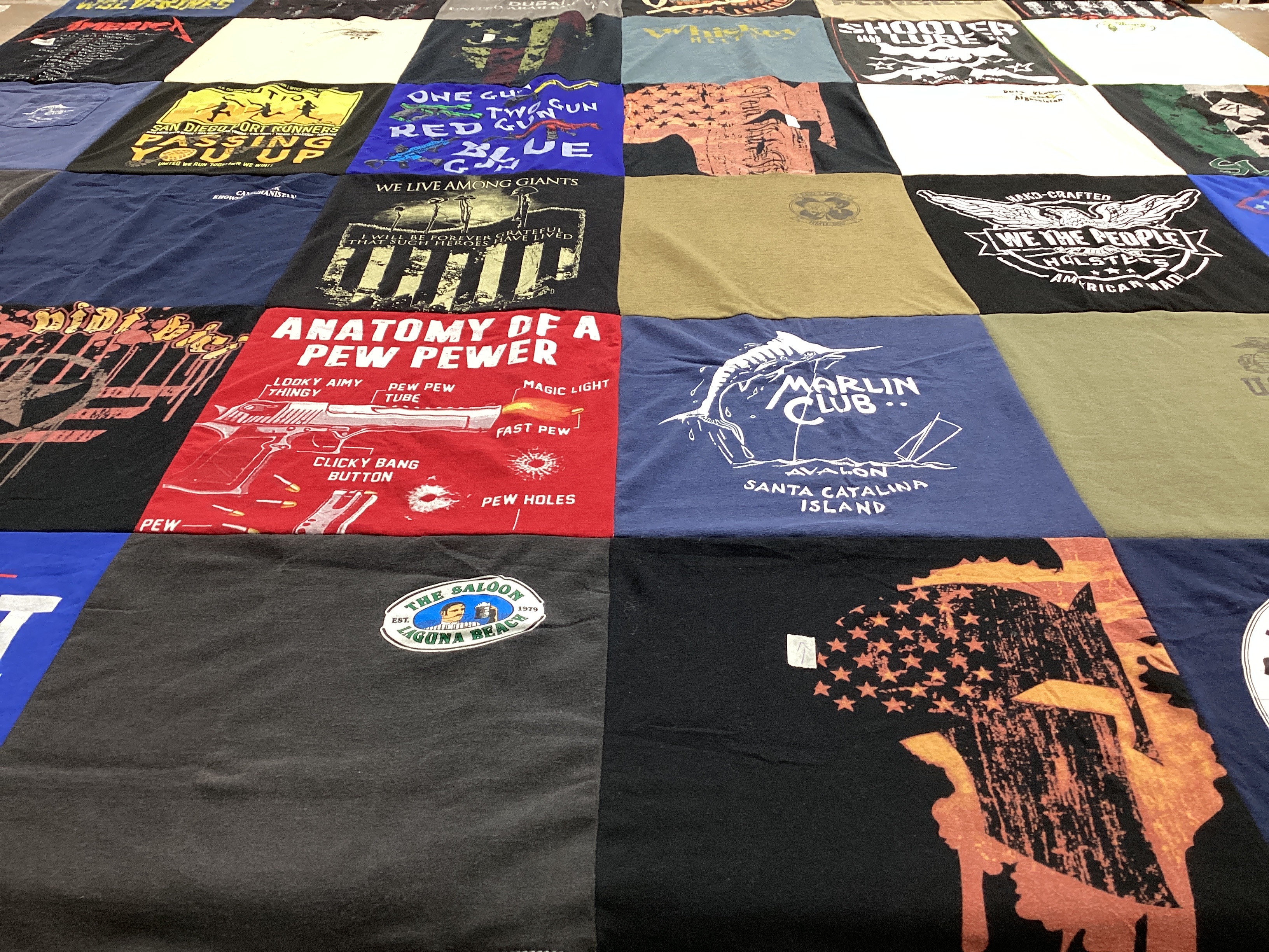 T-shirt quilt with fishing, firearms themes by Denton from CA
