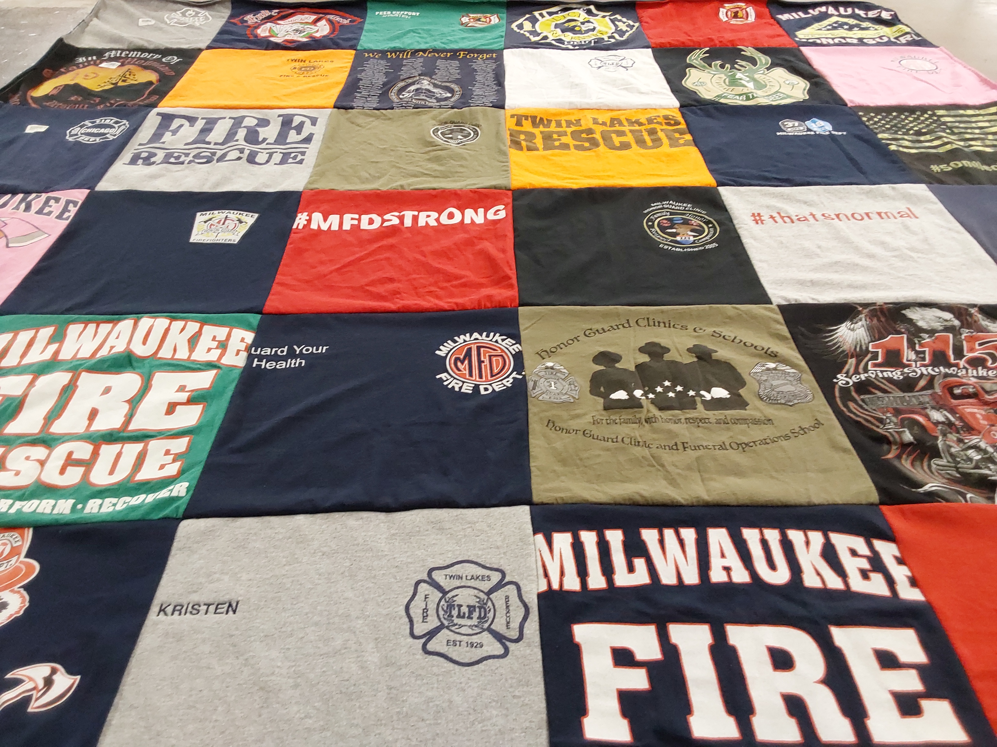 T-shirt quilt with firefighting, community service themes by Kristen from WI