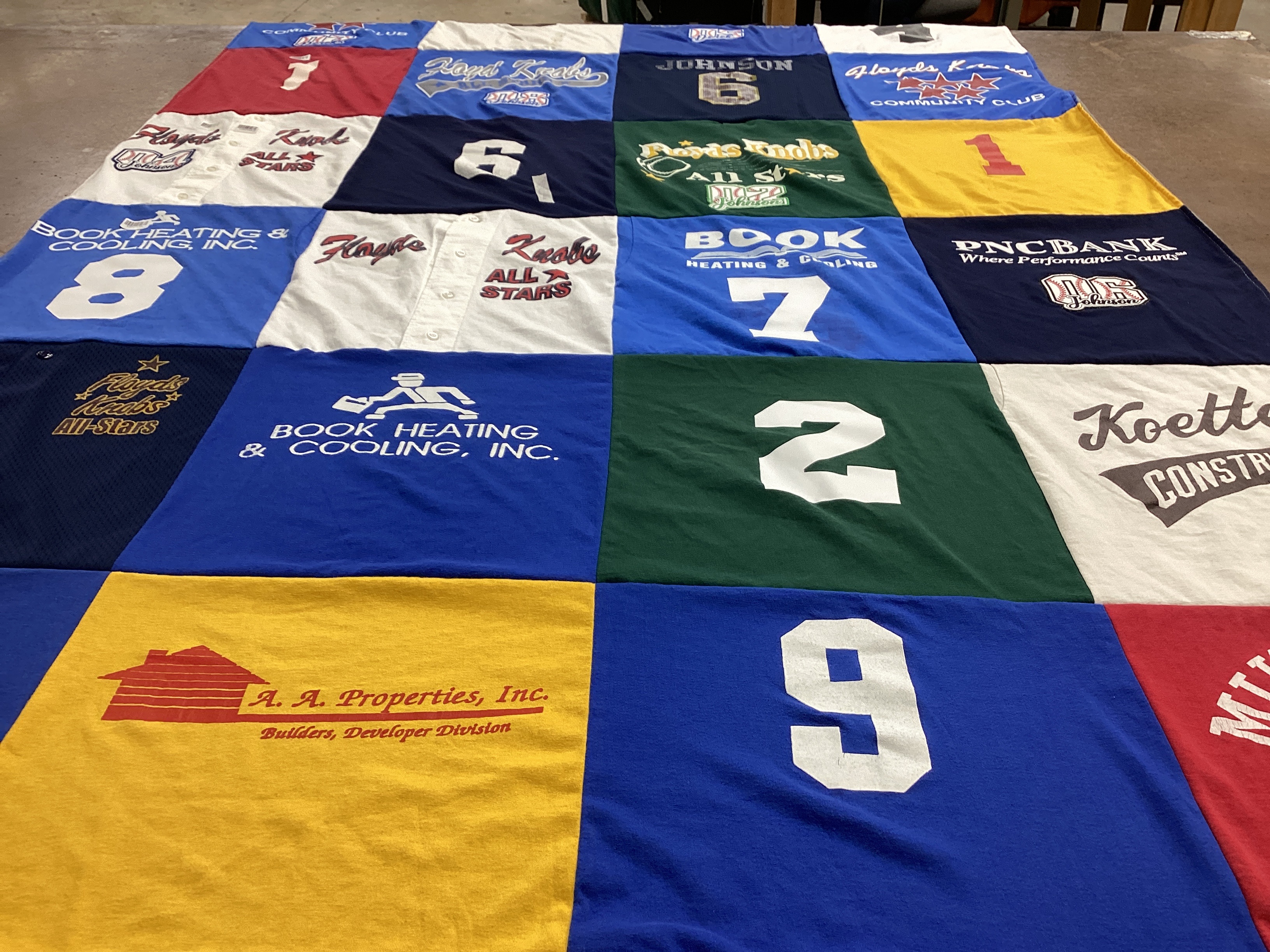T-shirt quilt with sports, community service themes by Pam from IN