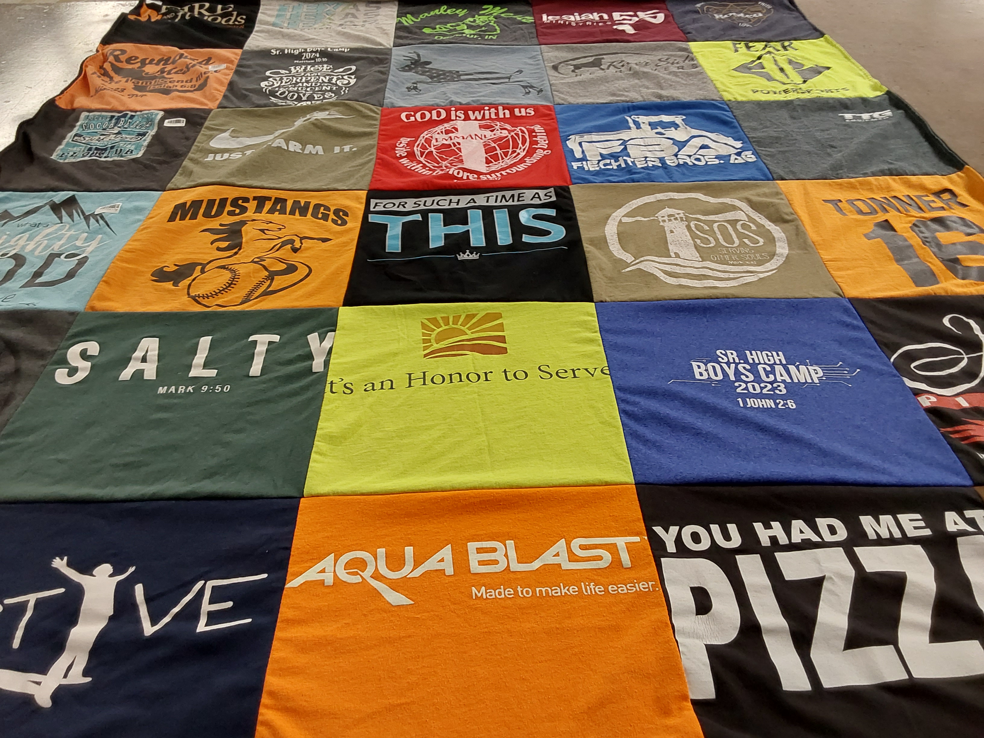 T-shirt quilt with sports, youth camps themes by Rachelle E from IN