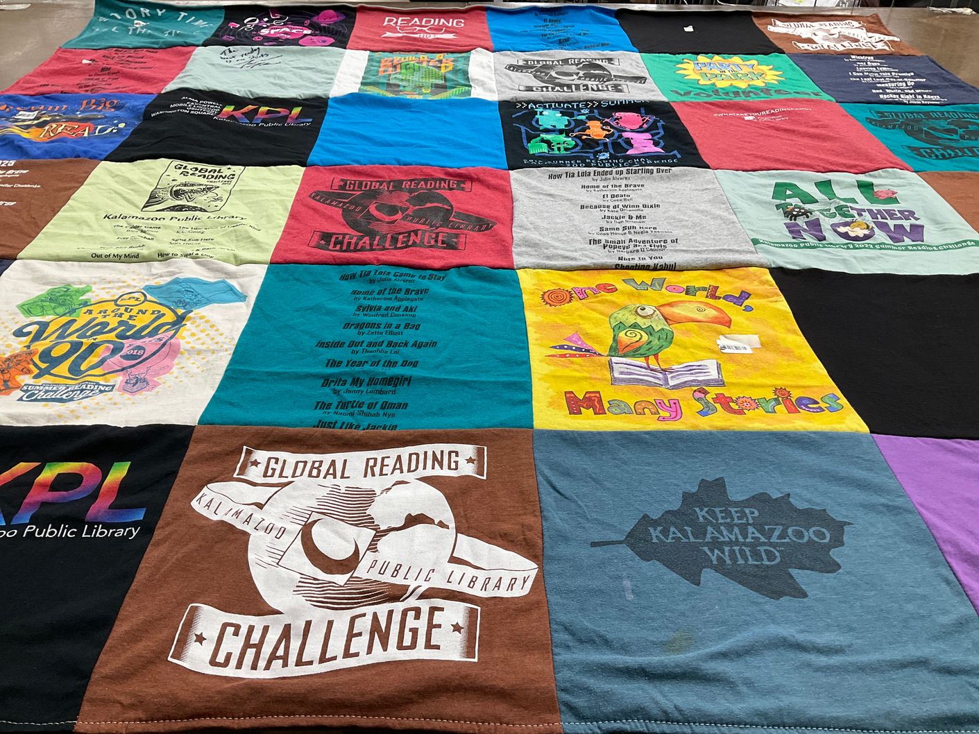 T-shirt quilt with reading, literature themes by Andrea from MI