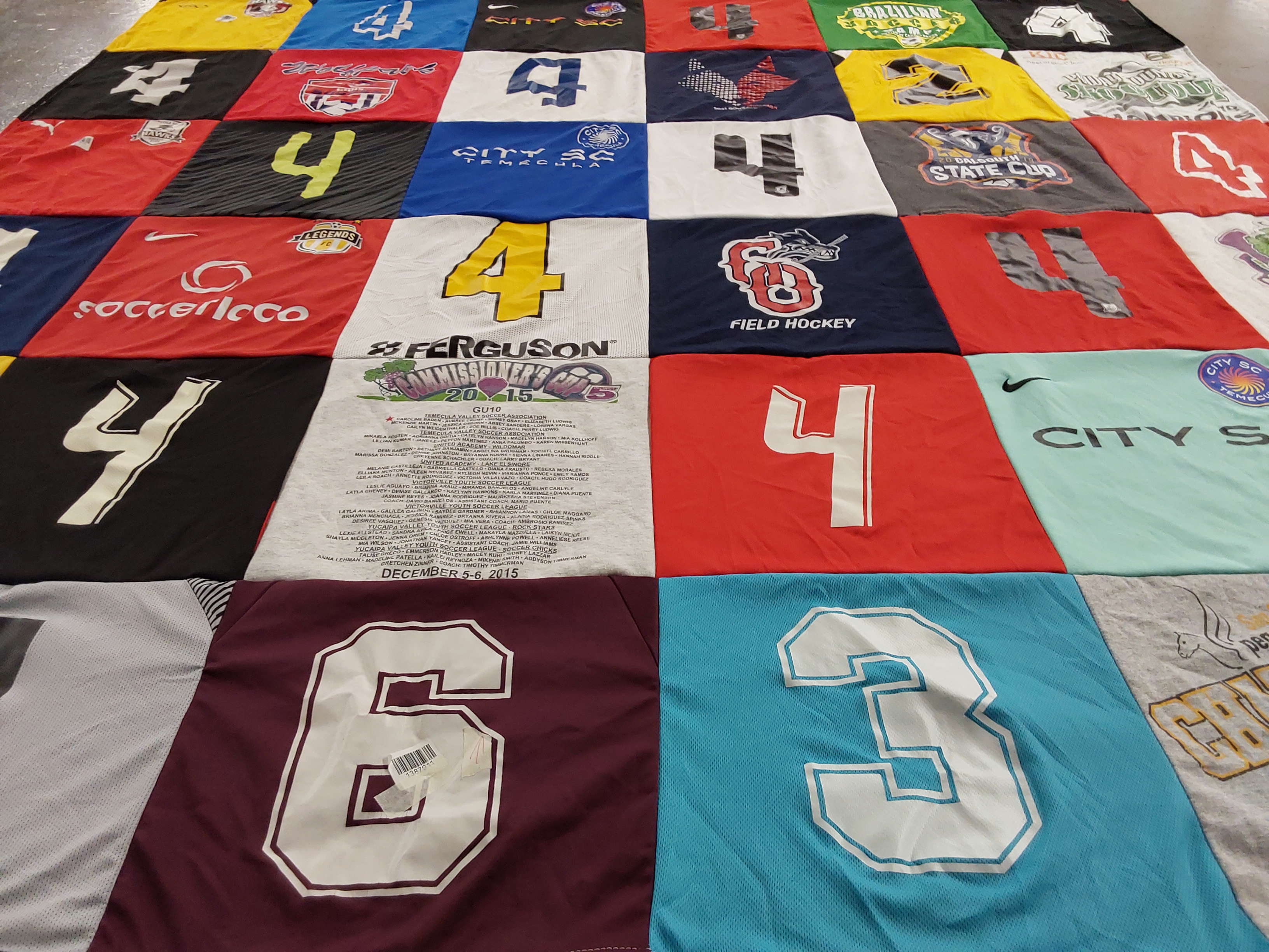T-shirt quilt with sports, hockey themes by Emily from CA
