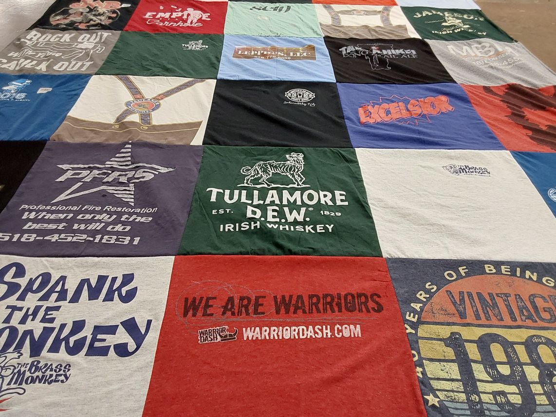 T-shirt quilt with fire safety, whiskey themes by Norbert from NY