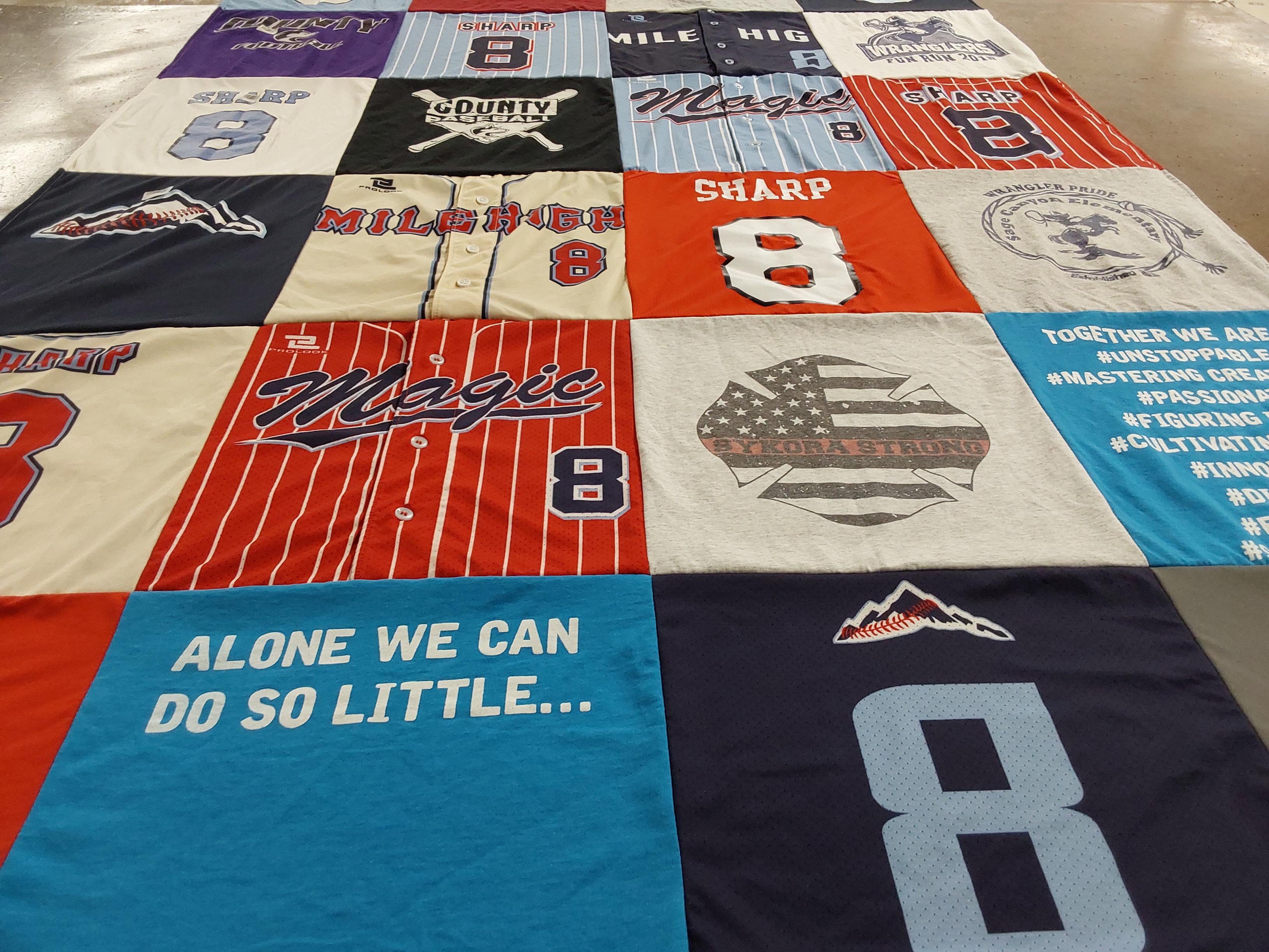T-shirt quilt with community, team spirit themes by Sally from CO
