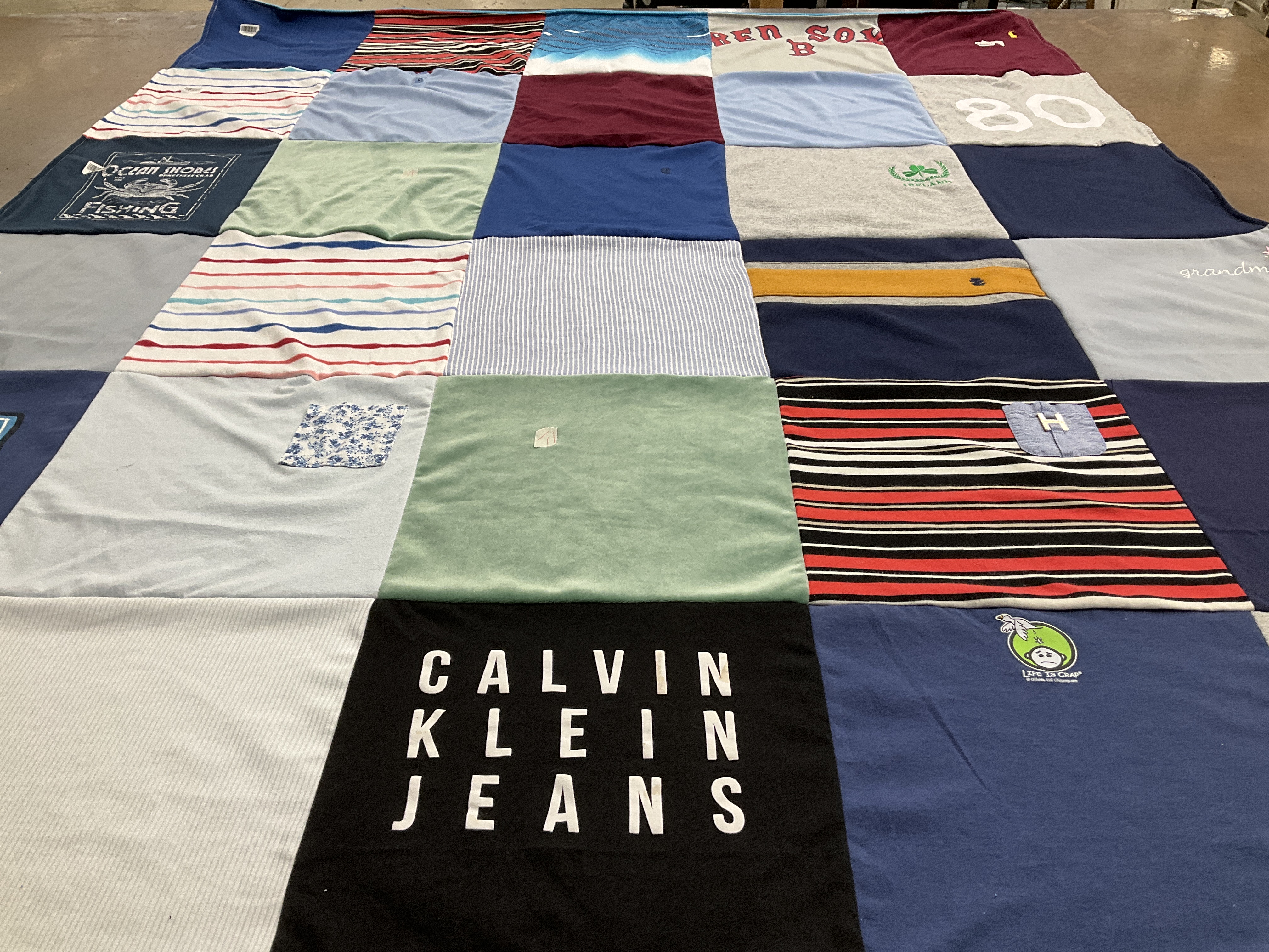 T-shirt quilt with fishing, golfing themes by judi from MA