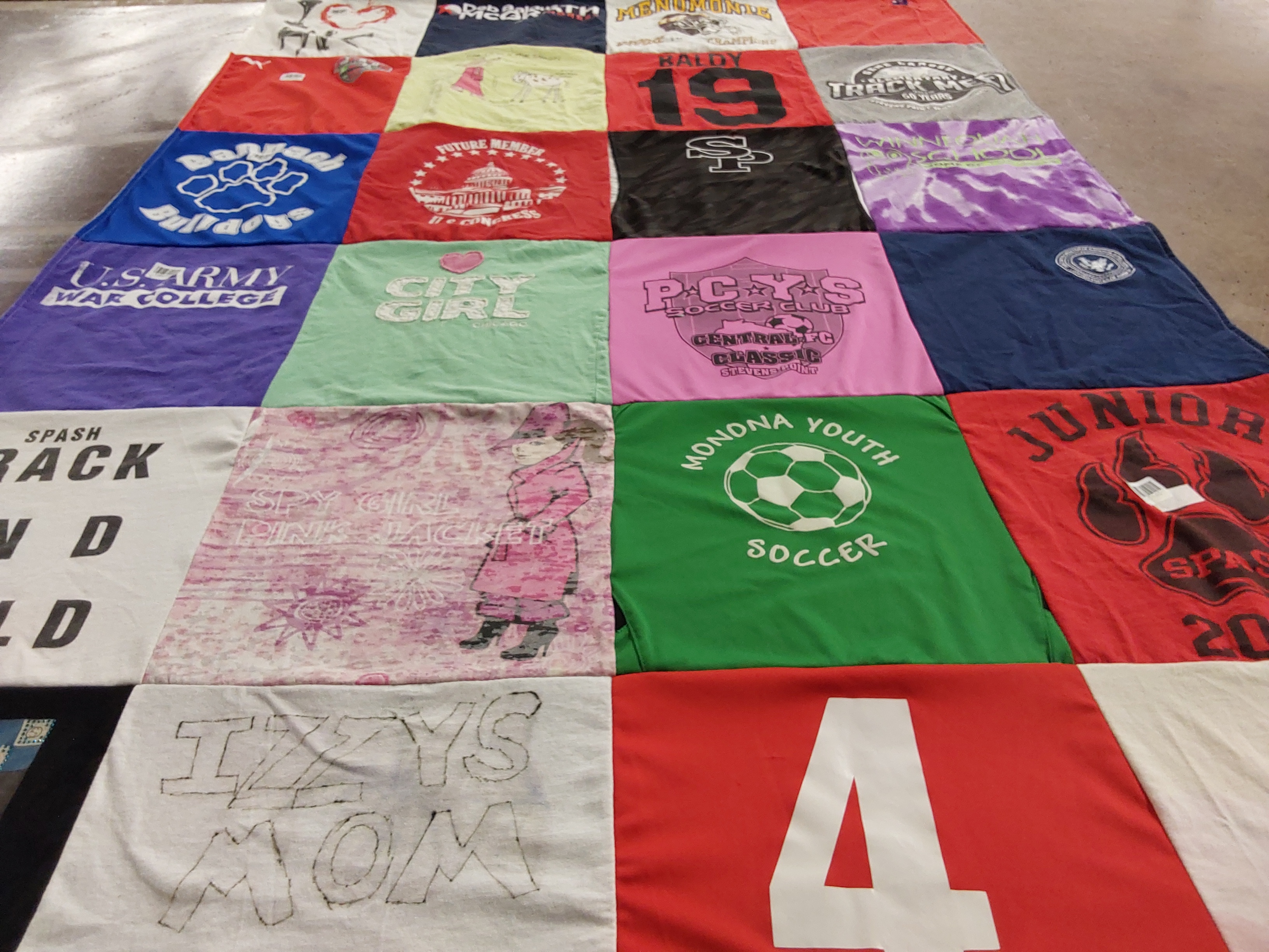 T-shirt quilt featuring monona youth soccer, spash track and field by John from WI