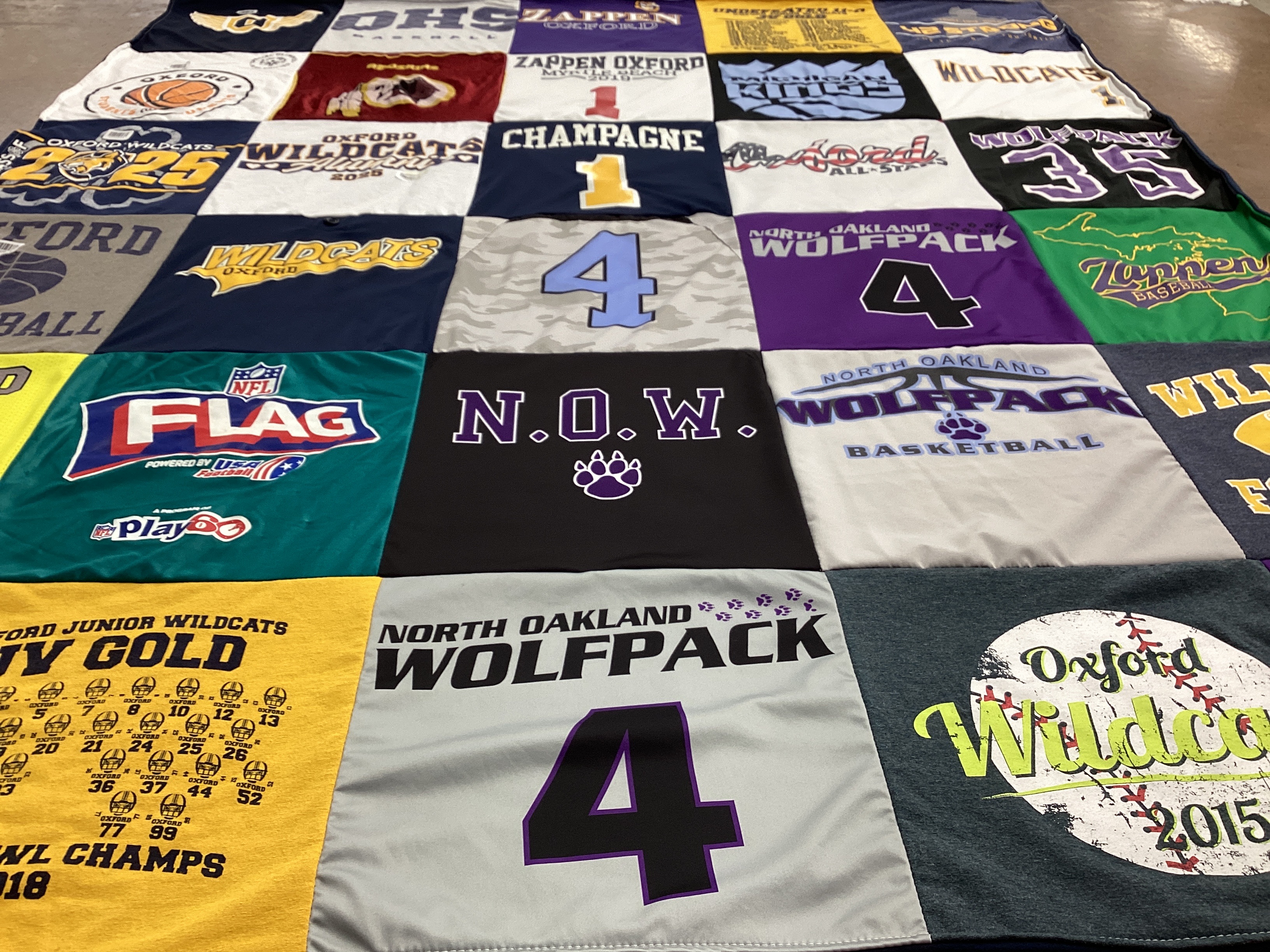 T-shirt quilt featuring north oakland wolfpack, oxford wildcats by Stefanie from MI