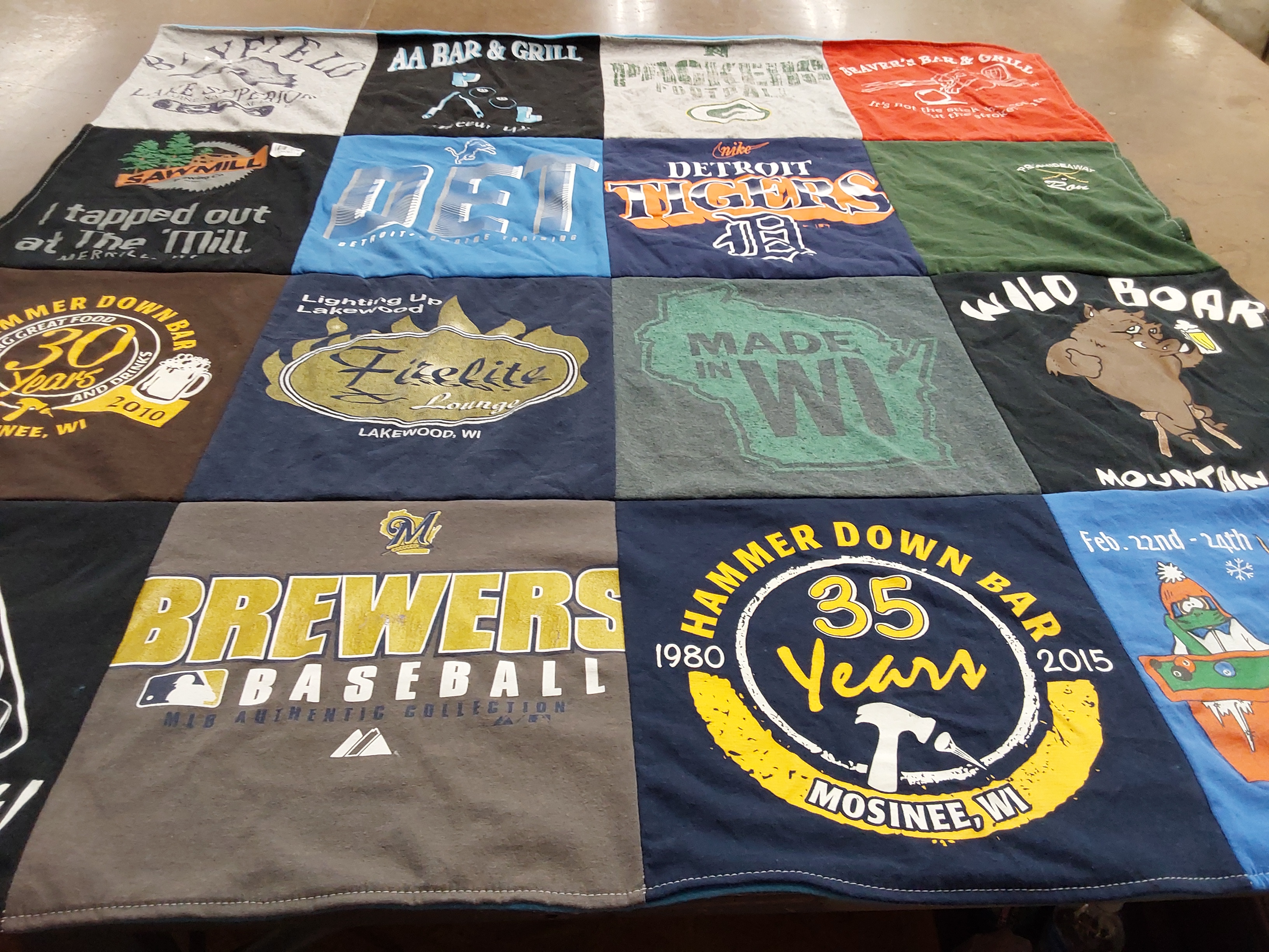 T-shirt quilt with sports, local businesses themes by Ron from WI
