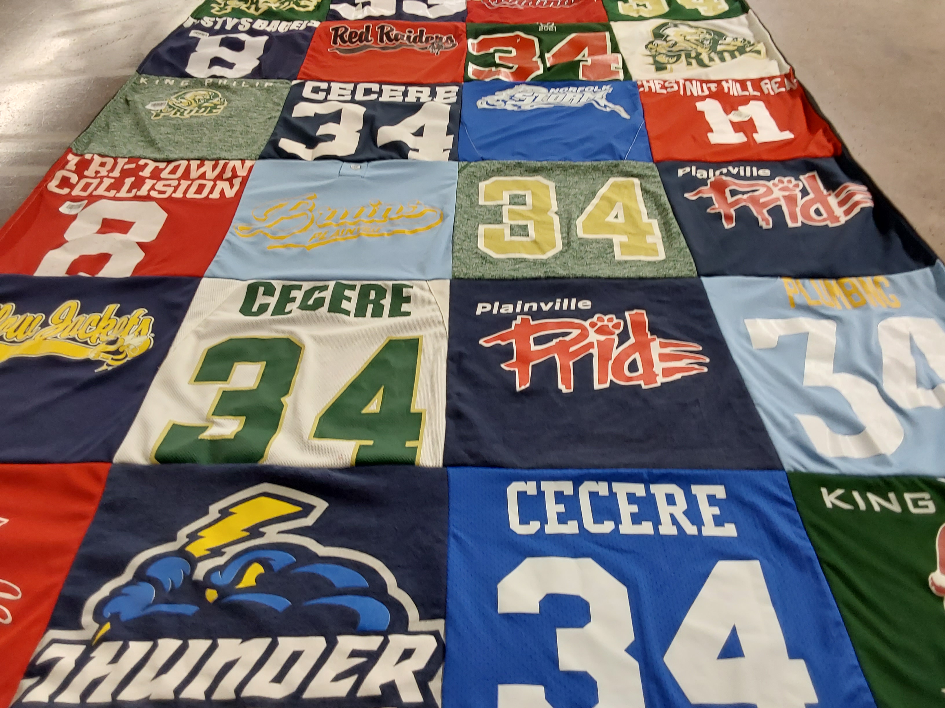 T-shirt quilt with sports, community themes by Elizabeth from MA