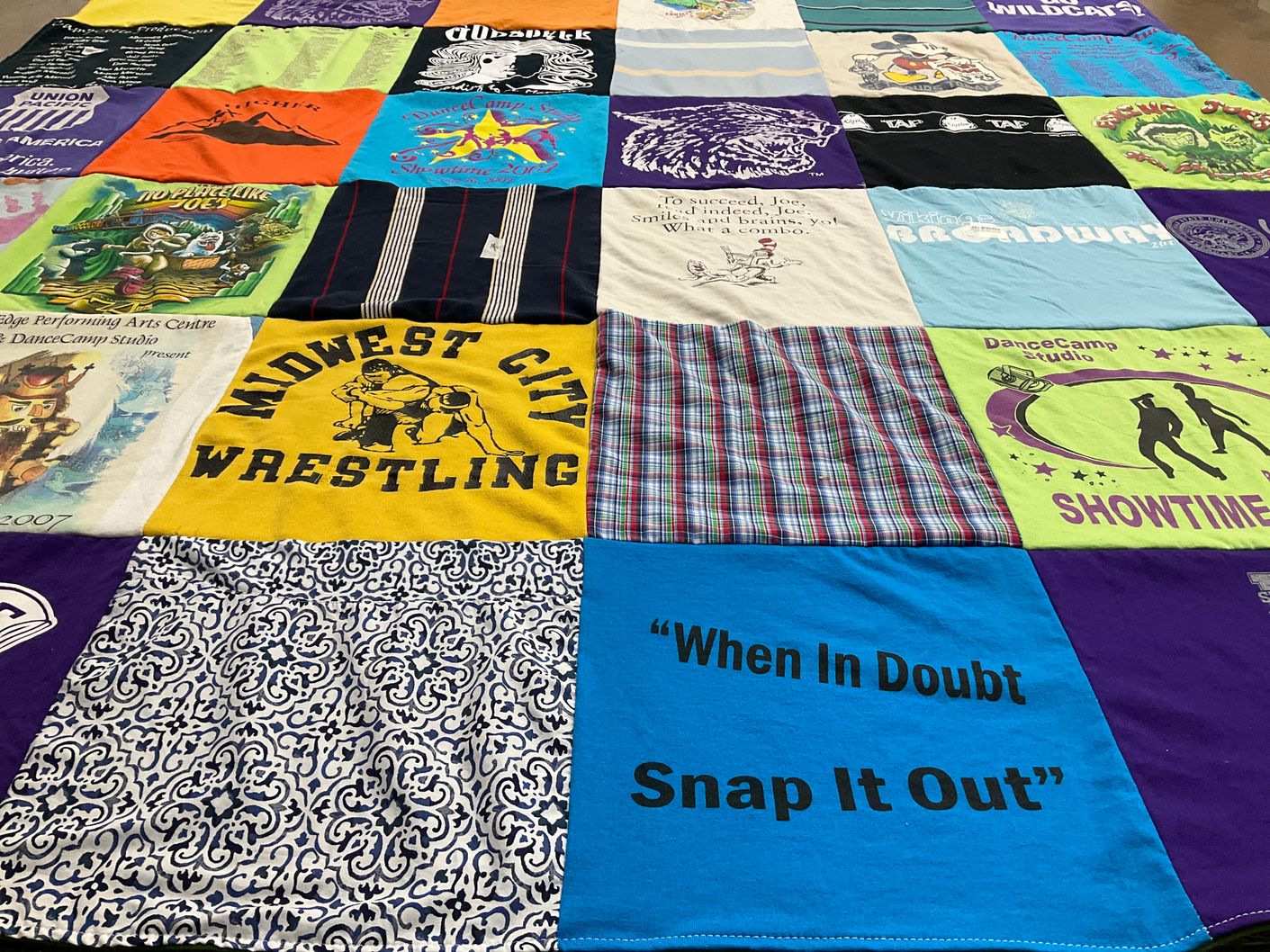T-shirt quilt with wrestling, dance themes by Susan from KS