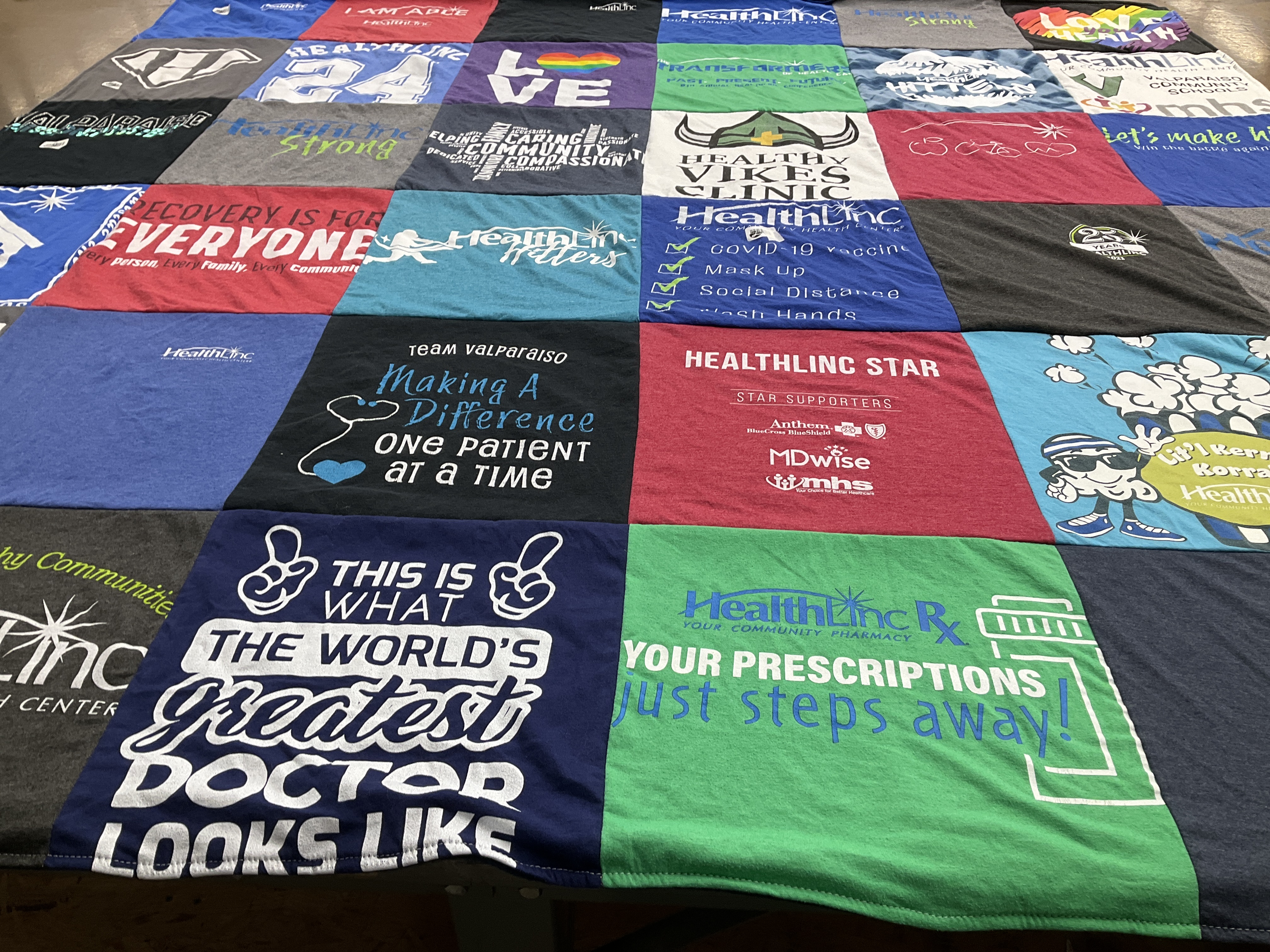 T-shirt quilt with healthcare, community service themes by Asha from IN