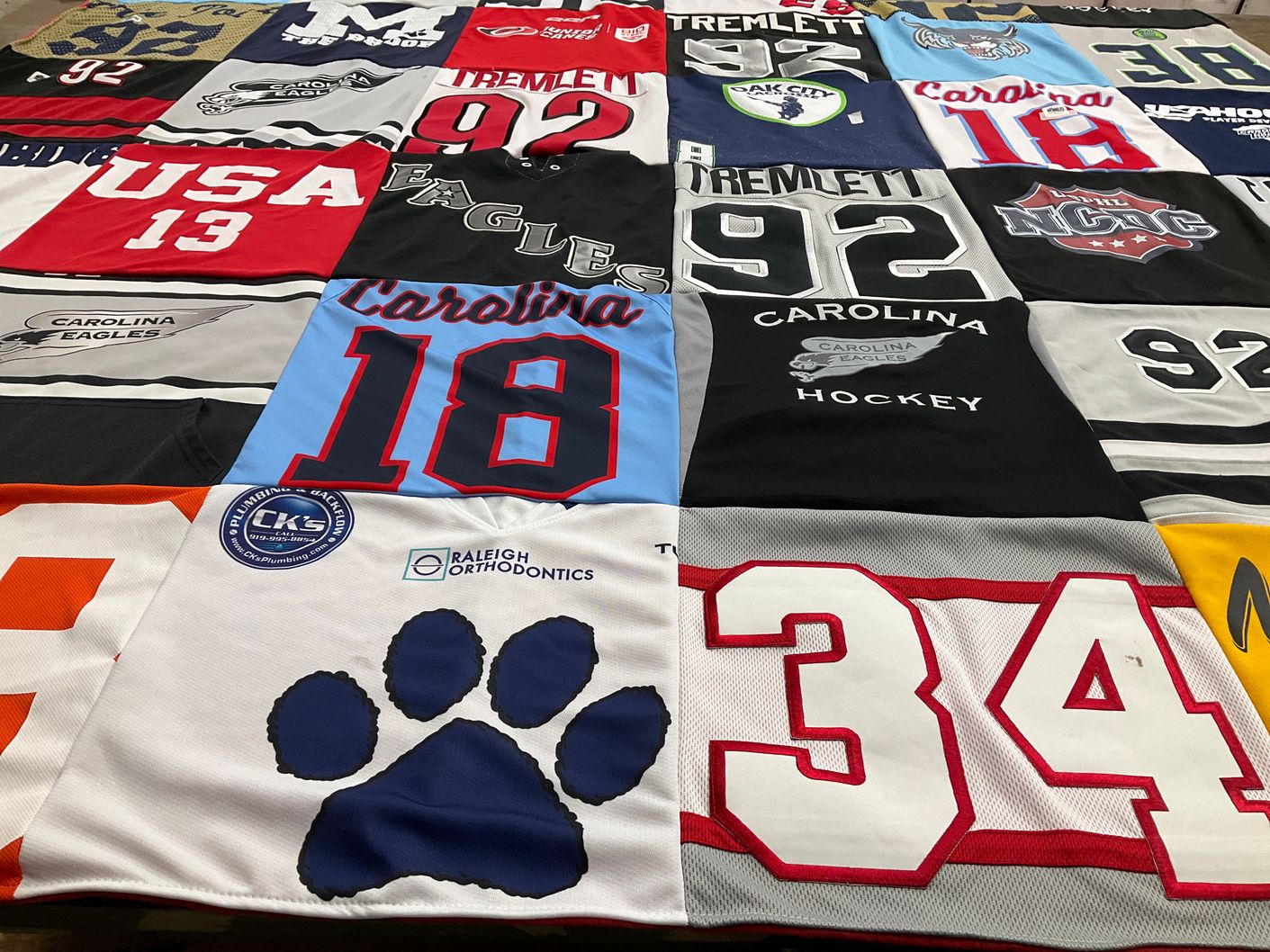 T-shirt quilt with hockey, sports themes by Jason from NC