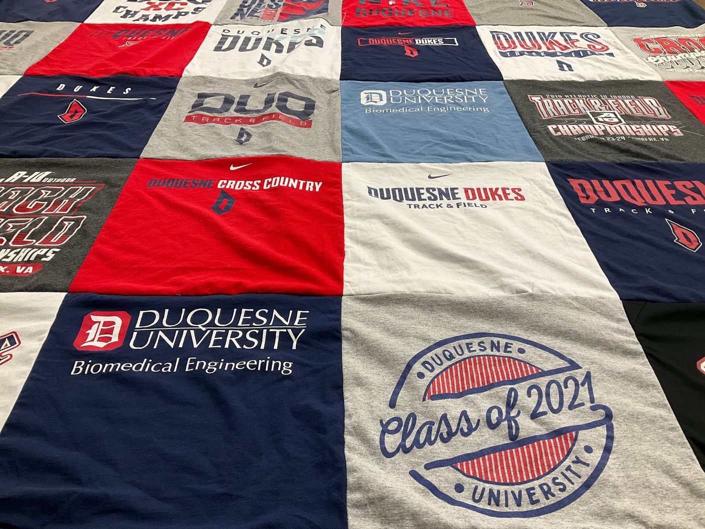 T-shirt quilt featuring duquesne dukes track and field, duquesne dukes cross country by Tori from PA