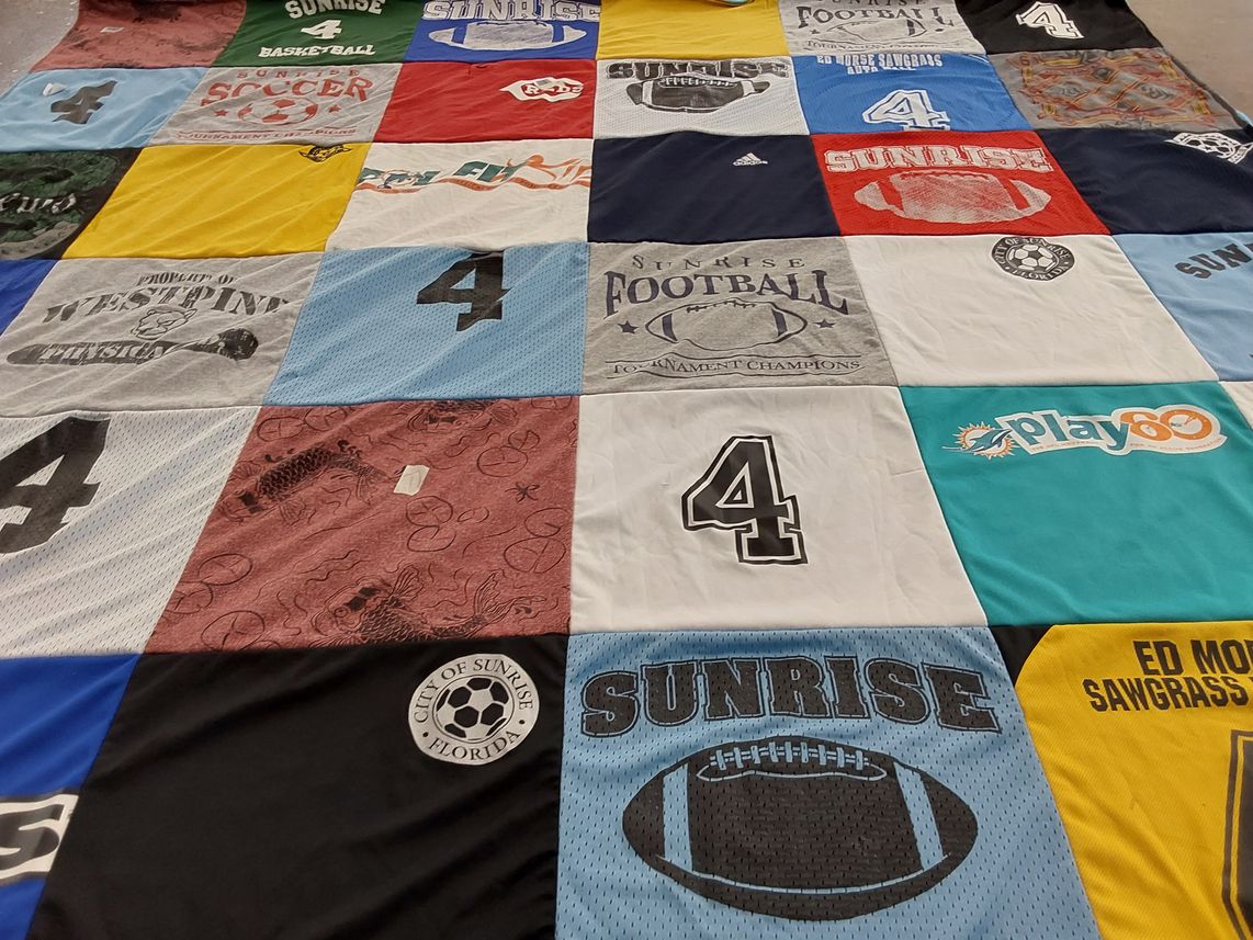 T-shirt quilt with sports, community events themes by Eileen from FL