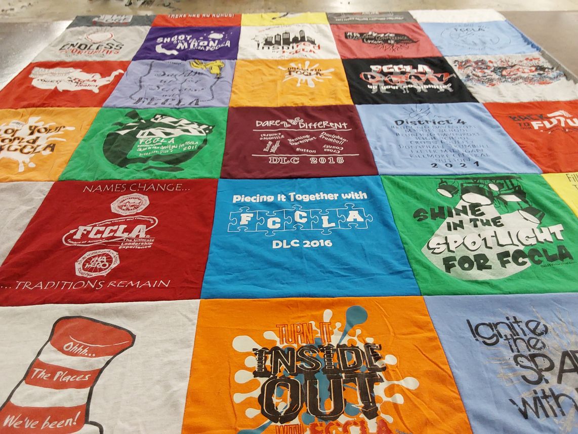 T-shirt quilt with family, career themes by Mary from NE