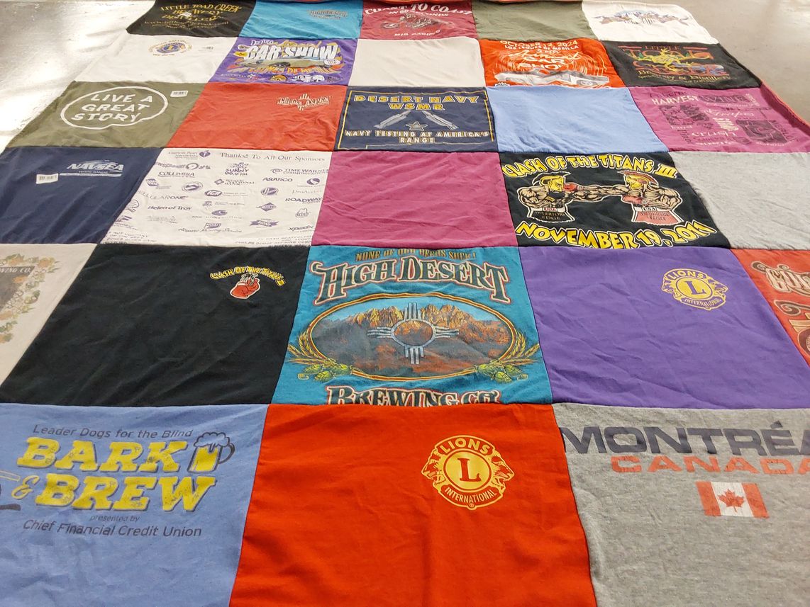 T-shirt quilt with pets, community service themes by Susan from NM