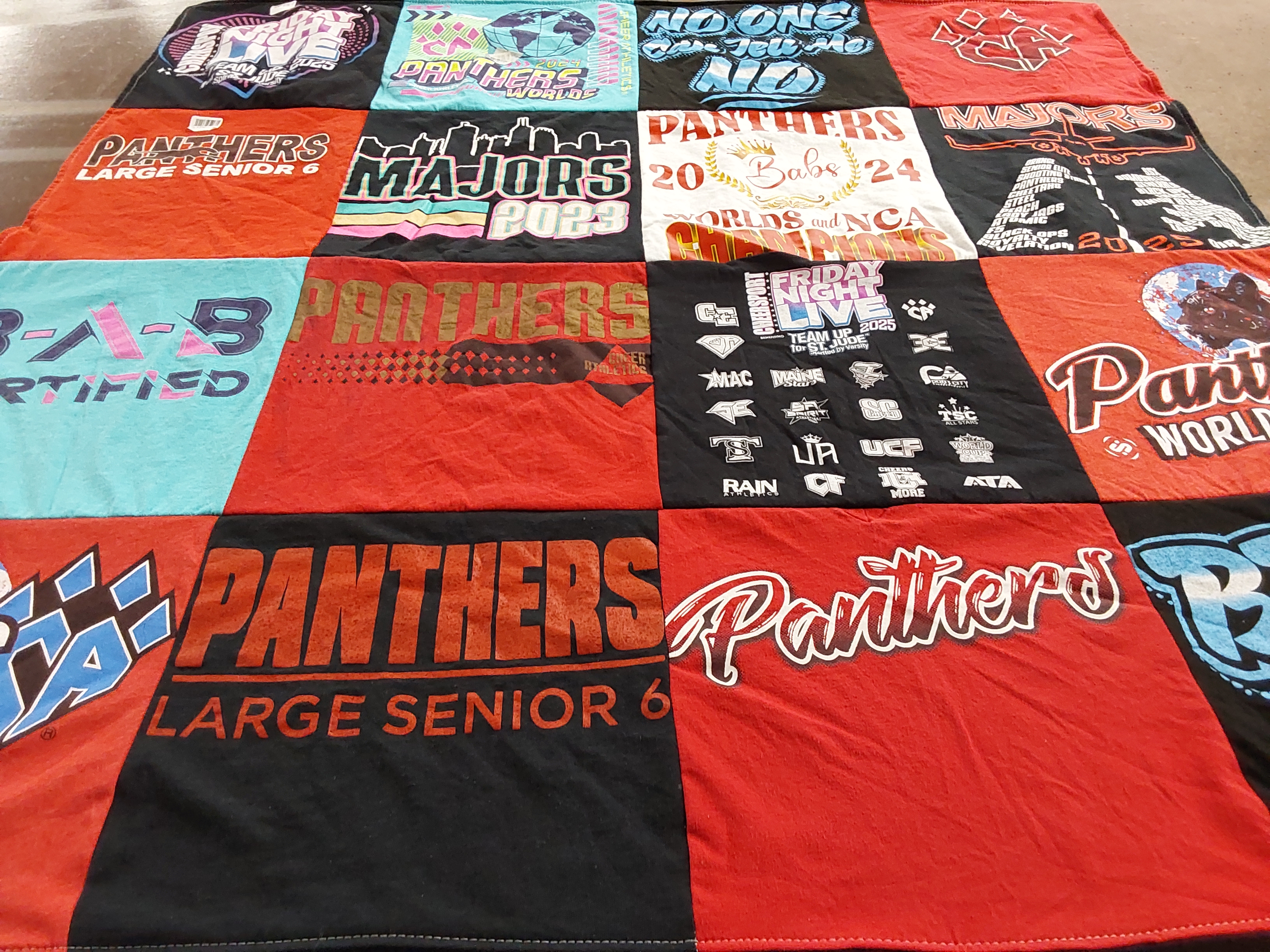 T-shirt quilt with cheerleading, sports themes by Kamryn from TX