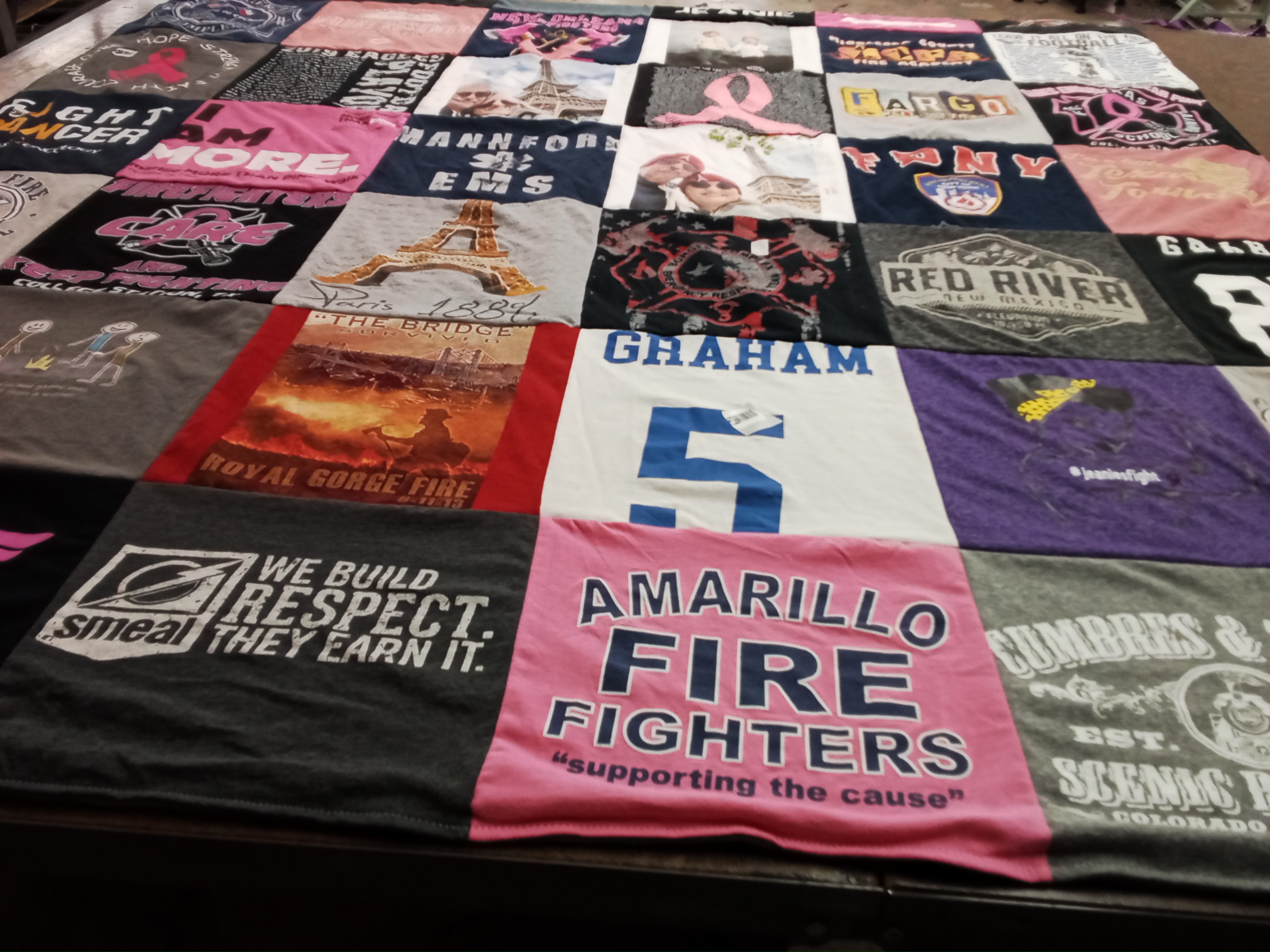 T-shirt quilt with firefighting, community service themes by Sheila from TX