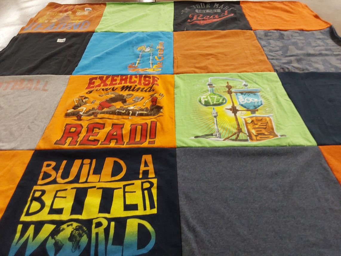T-shirt quilt with reading, exercise themes by Amy from WI