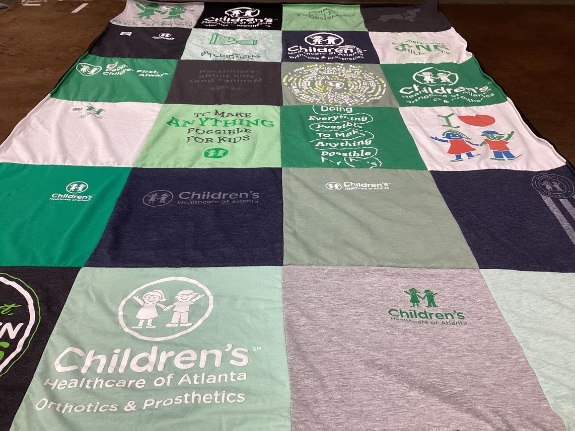 T-shirt quilt with healthcare, children's welfare themes by Amy from GA