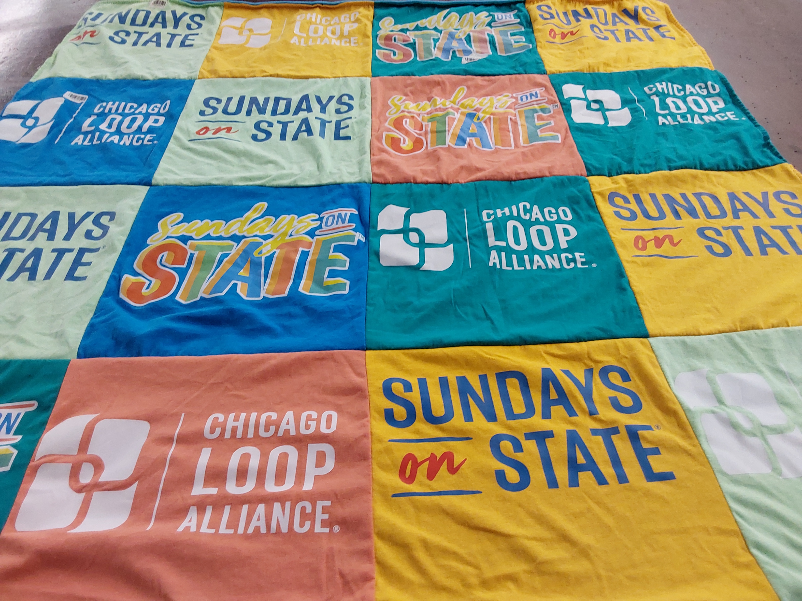 T-shirt quilt with community events, urban culture themes by Allison from IL