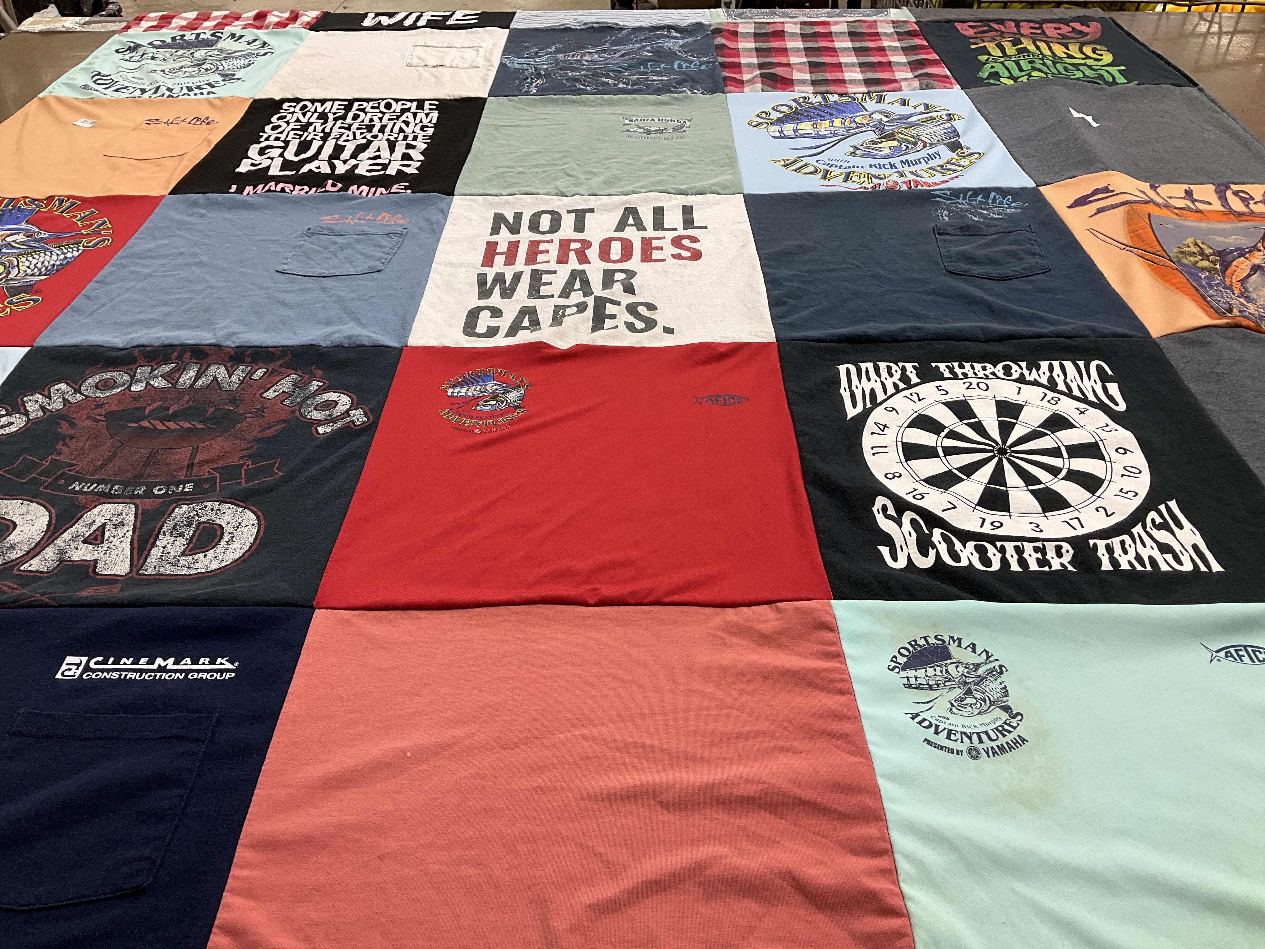 T-shirt quilt with dart throwing, fishing themes by Rise from GA