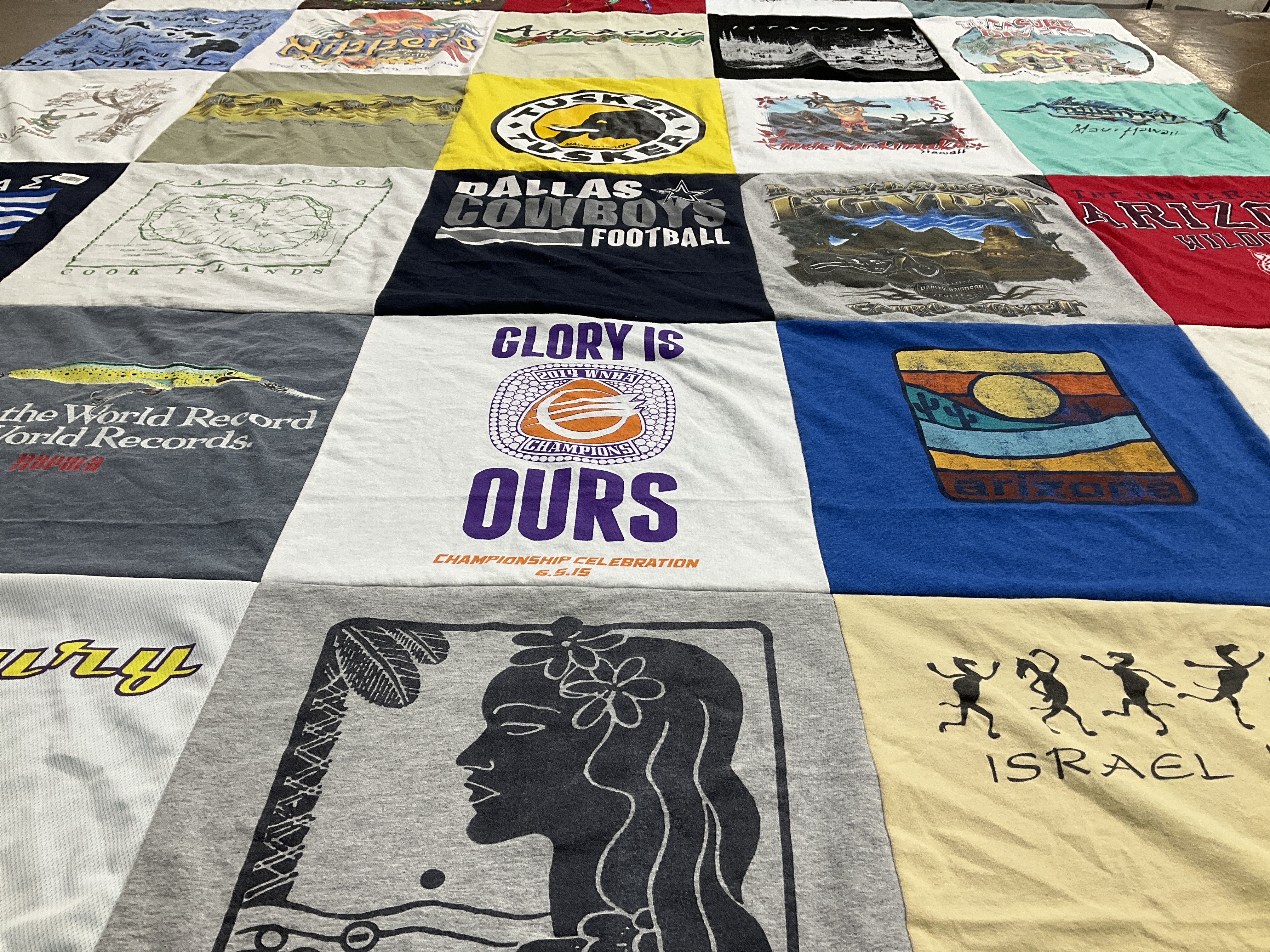 T-shirt quilt with sports, travel themes by Kristina from HI