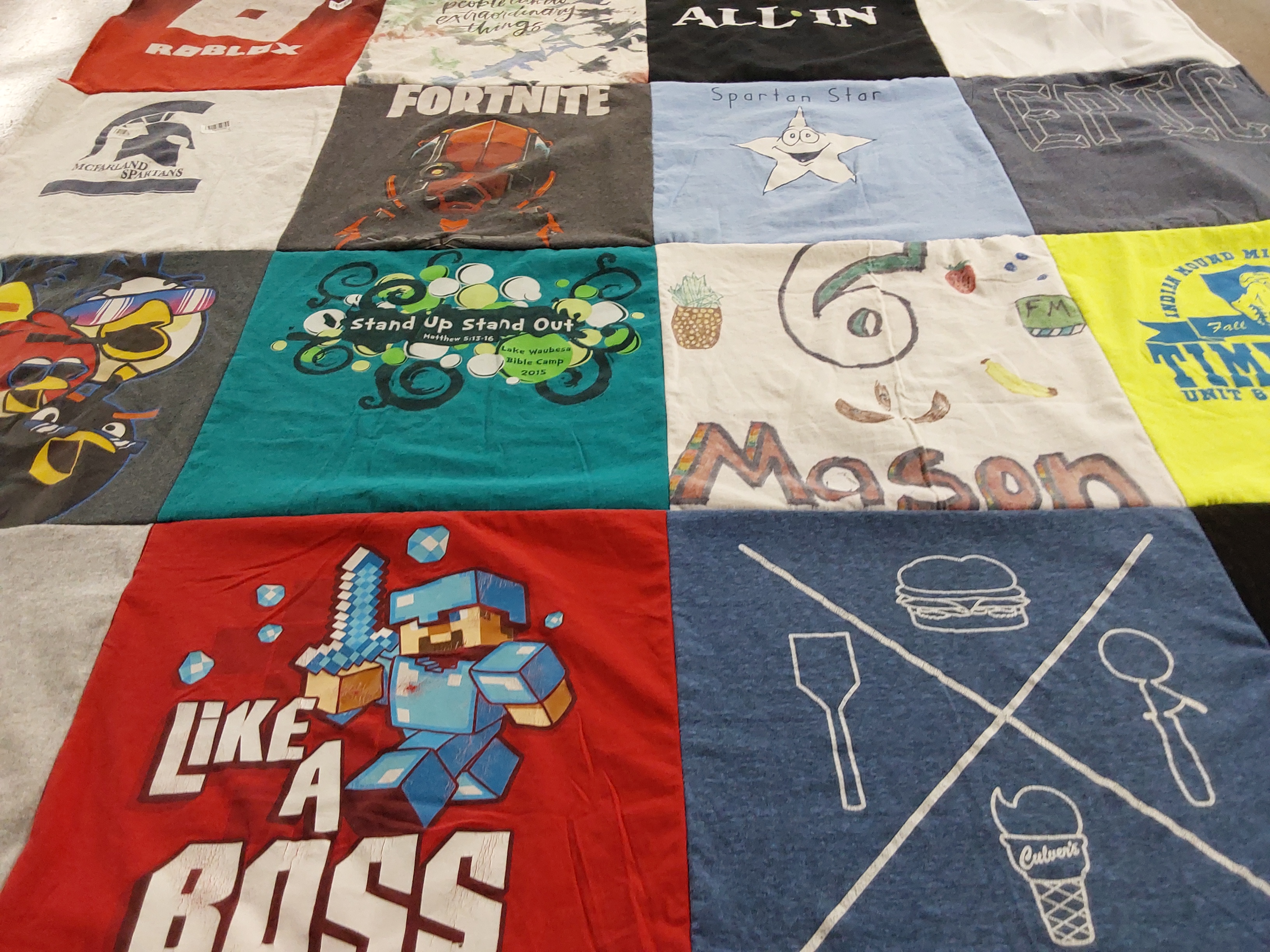 T-shirt quilt with gaming, bible camp themes by Jenna from WI