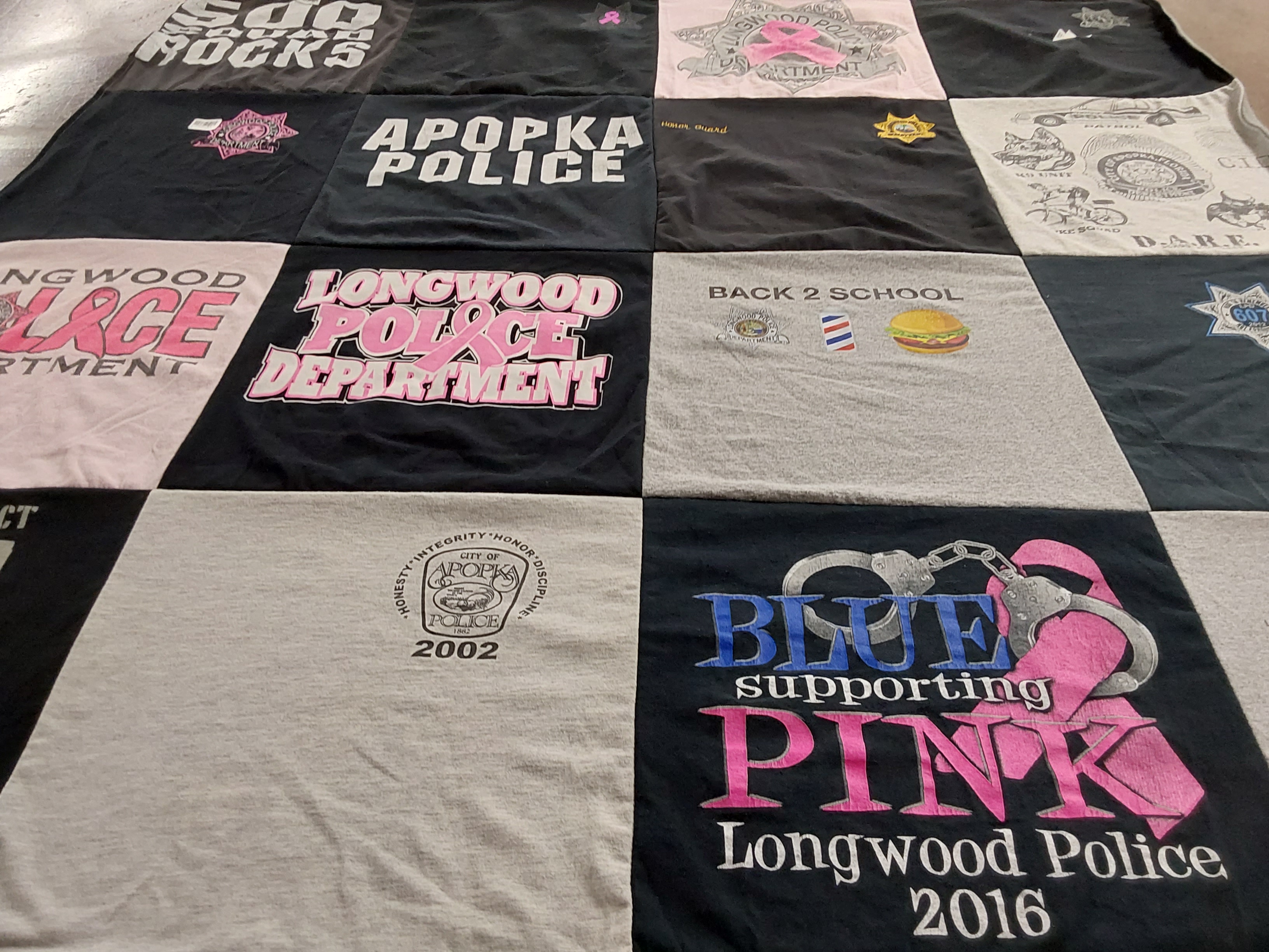 T-shirt quilt with law enforcement, community service themes by Marie from FL
