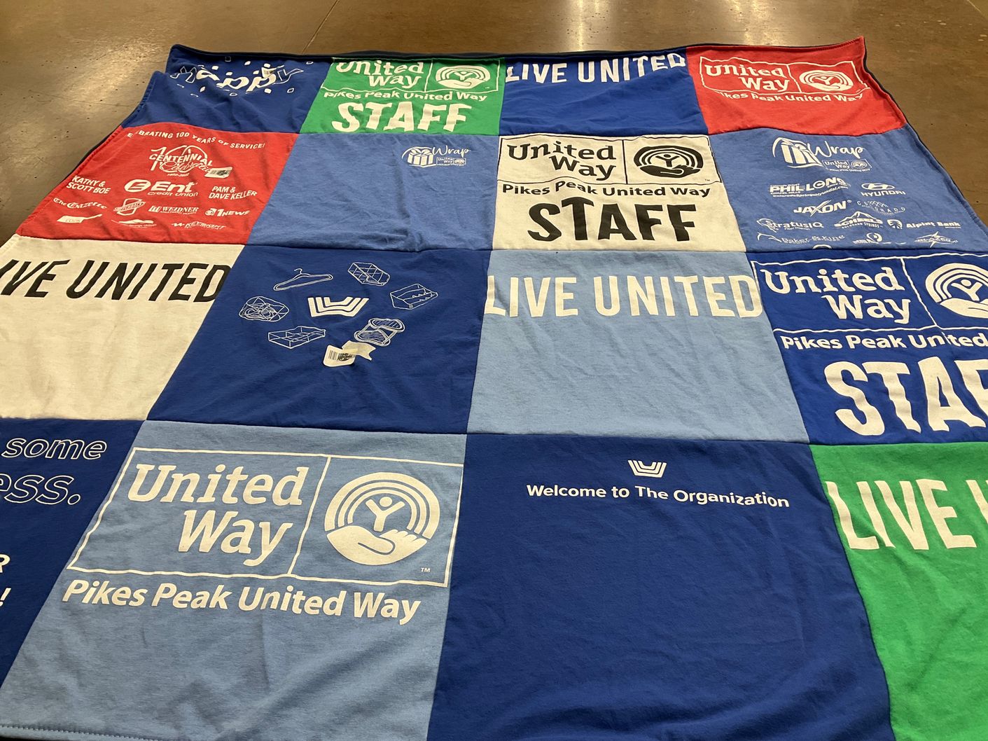 T-shirt quilt with community service, nonprofit work themes by Mary from CO
